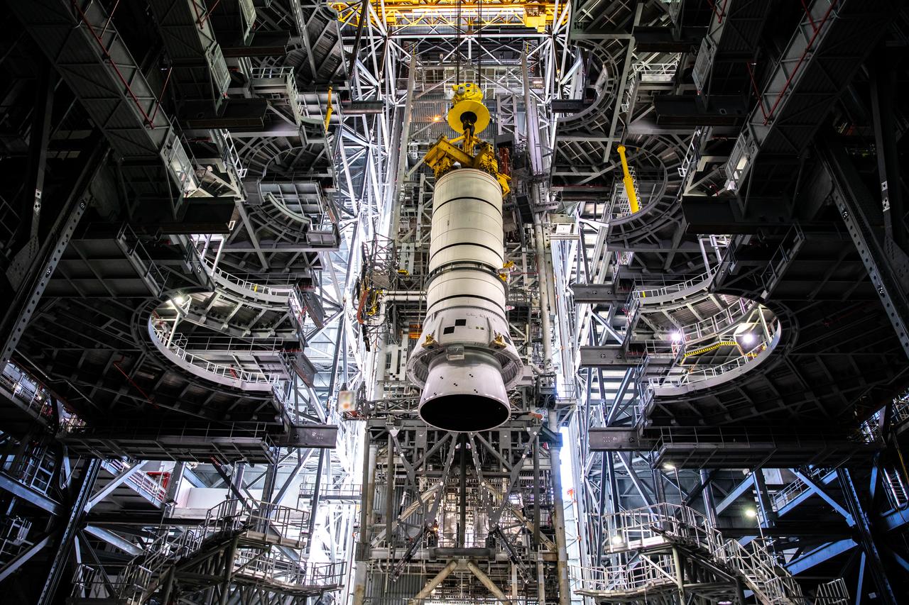 During a training exercise, technicians with NASA’s Exploration Ground Systems lower a mock-up of the Space Launch System (SLS) aft booster segment, referred to as a pathfinder, onto the mobile launcher in Kennedy Space Center’s Vehicle Assembly Building (VAB) on Sept. 11, 2020. The rehearsal involved teams preparing the aft pathfinder segment in High Bay 4 of the VAB, lifting and moving it over to High Bay 3, and placing it on the mobile launcher in preparation for Artemis I. Stacking of the actual booster segments will occur later this year, before the SLS core stage arrives at the Florida spaceport. Artemis I is the first in a series of increasingly complex missions that will test SLS and the Orion spacecraft as an integrated system prior to crewed flights to the Moon.