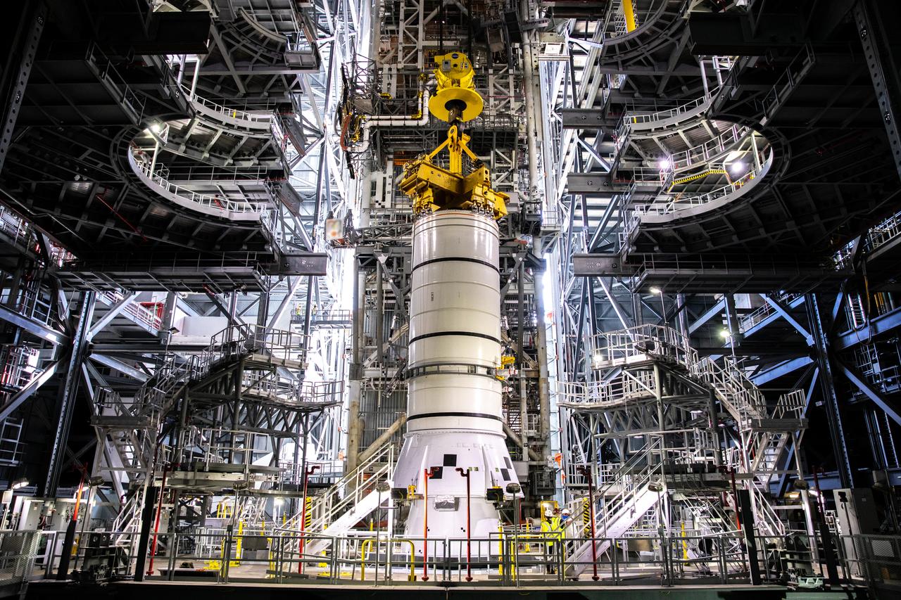 During a training exercise, technicians with NASA’s Exploration Ground Systems lower a mock-up of the Space Launch System (SLS) aft booster segment, referred to as a pathfinder, onto the mobile launcher in Kennedy Space Center’s Vehicle Assembly Building (VAB) on Sept. 11, 2020. The rehearsal involved teams preparing the aft pathfinder segment in High Bay 4 of the VAB, lifting and moving it over to High Bay 3, and placing it on the mobile launcher in preparation for Artemis I. Stacking of the actual booster segments will occur later this year, before the SLS core stage arrives at the Florida spaceport. Artemis I is the first in a series of increasingly complex missions that will test SLS and the Orion spacecraft as an integrated system prior to crewed flights to the Moon.