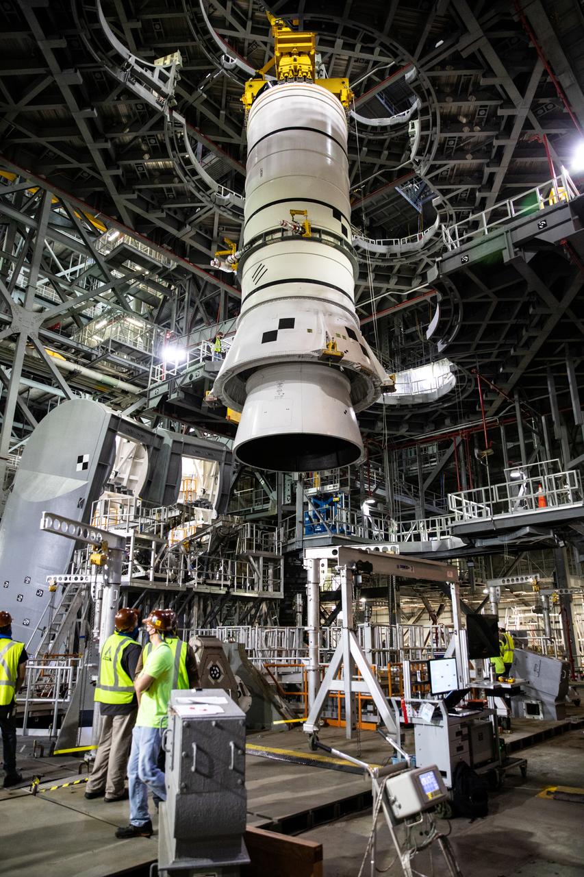 During a training exercise, technicians with NASA’s Exploration Ground Systems lower a mock-up of the Space Launch System (SLS) aft booster segment, referred to as a pathfinder, onto the mobile launcher in Kennedy Space Center’s Vehicle Assembly Building (VAB) on Sept. 11, 2020. The rehearsal involved teams preparing the aft pathfinder segment in High Bay 4 of the VAB, lifting and moving it over to High Bay 3, and placing it on the mobile launcher in preparation for Artemis I. Stacking of the actual booster segments will occur later this year, before the SLS core stage arrives at the Florida spaceport. Artemis I is the first in a series of increasingly complex missions that will test SLS and the Orion spacecraft as an integrated system prior to crewed flights to the Moon.