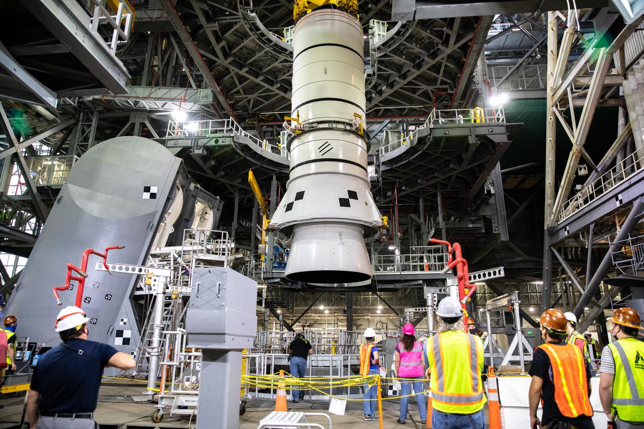 During a training exercise, technicians with NASA’s Exploration Ground Systems lower a mock-up of the Space Launch System (SLS) aft booster segment, referred to as a pathfinder, onto the mobile launcher in Kennedy Space Center’s Vehicle Assembly Building (VAB) on Sept. 11, 2020. The rehearsal involved teams preparing the aft pathfinder segment in High Bay 4 of the VAB, lifting and moving it over to High Bay 3, and placing it on the mobile launcher in preparation for Artemis I. Stacking of the actual booster segments will occur later this year, before the SLS core stage arrives at the Florida spaceport. Artemis I is the first in a series of increasingly complex missions that will test SLS and the Orion spacecraft as an integrated system prior to crewed flights to the Moon.