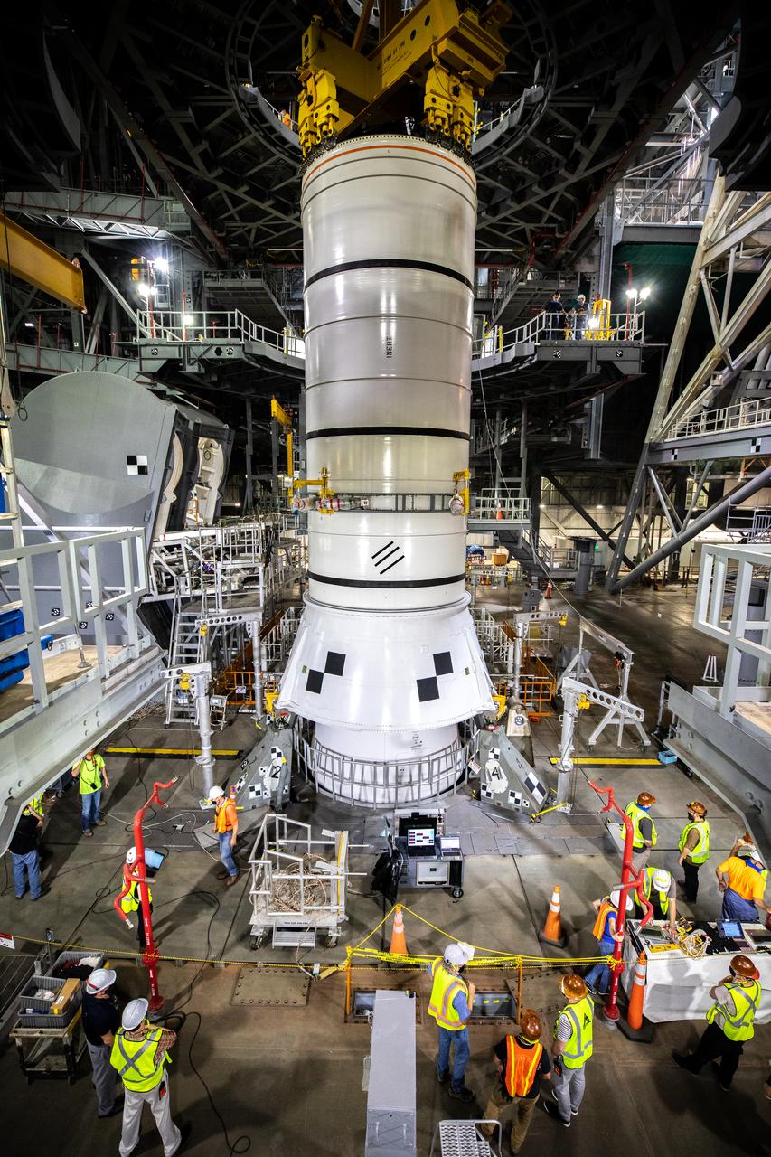 During a training exercise, technicians with NASA’s Exploration Ground Systems lower a mock-up of the Space Launch System (SLS) aft booster segment, referred to as a pathfinder, onto the mobile launcher in Kennedy Space Center’s Vehicle Assembly Building (VAB) on Sept. 11, 2020. The rehearsal involved teams preparing the aft pathfinder segment in High Bay 4 of the VAB, lifting and moving it over to High Bay 3, and placing it on the mobile launcher in preparation for Artemis I. Stacking of the actual booster segments will occur later this year, before the SLS core stage arrives at the Florida spaceport. Artemis I is the first in a series of increasingly complex missions that will test SLS and the Orion spacecraft as an integrated system prior to crewed flights to the Moon.