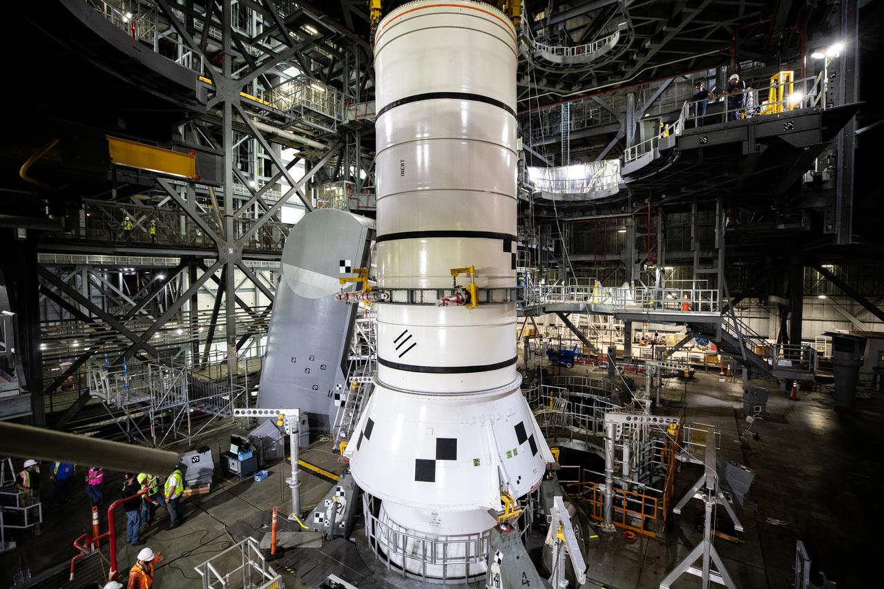 During a training exercise, technicians with NASA’s Exploration Ground Systems lower a mock-up of the Space Launch System (SLS) aft booster segment, referred to as a pathfinder, onto the mobile launcher in Kennedy Space Center’s Vehicle Assembly Building (VAB) on Sept. 11, 2020. The rehearsal involved teams preparing the aft pathfinder segment in High Bay 4 of the VAB, lifting and moving it over to High Bay 3, and placing it on the mobile launcher in preparation for Artemis I. Stacking of the actual booster segments will occur later this year, before the SLS core stage arrives at the Florida spaceport. Artemis I is the first in a series of increasingly complex missions that will test SLS and the Orion spacecraft as an integrated system prior to crewed flights to the Moon.