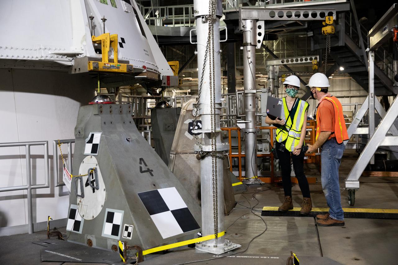 During a training exercise on Sept. 11, 2020, inside the Vehicle Assembly (VAB) at NASA’s Kennedy Space Center in Florida, technicians with the agency’s Exploration Ground Systems verify a mock-up of the Space Launch System (SLS) aft booster segment, referred to as a pathfinder, was placed on the mobile launcher correctly. The rehearsal involved teams preparing the aft pathfinder segment in High Bay 4 of the VAB, lifting and moving it over to High Bay 3, and lowering it onto the mobile launcher in preparation for Artemis I. Stacking of the actual booster segments will occur later this year, before the SLS core stage arrives at the Florida spaceport. Artemis I is the first in a series of increasingly complex missions that will test SLS and the Orion spacecraft as an integrated system prior to crewed flights to the Moon.