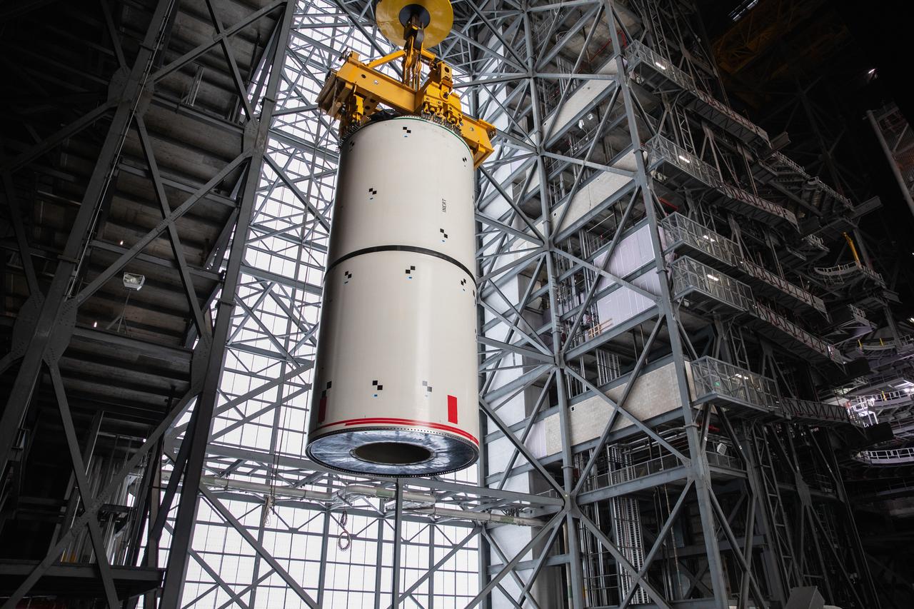 Technicians with NASA’s Exploration Ground Systems rehearse booster stacking operations inside the Vehicle Assembly Building (VAB) at the agency’s Kennedy Space Center in Florida on Sept. 14, 2020, in preparation for Artemis I. The exercise involved using booster segment mock-ups, referred to as pathfinders. During the rehearsal, an aft pathfinder segment was prepared in High Bay 4 of the VAB, after which a team of crane operators moved it over to High Bay 3, where it was placed on the mobile launcher. Careful measurements were then taken before the team added a center pathfinder to the stack. Stacking of the actual Space Launch System (SLS) booster segments will occur later this year, when the rocket’s core stage arrives at Kennedy. Artemis I is the first in a series of increasingly complex missions that will test SLS and the Orion spacecraft as an integrated system prior to crewed flights to the Moon.