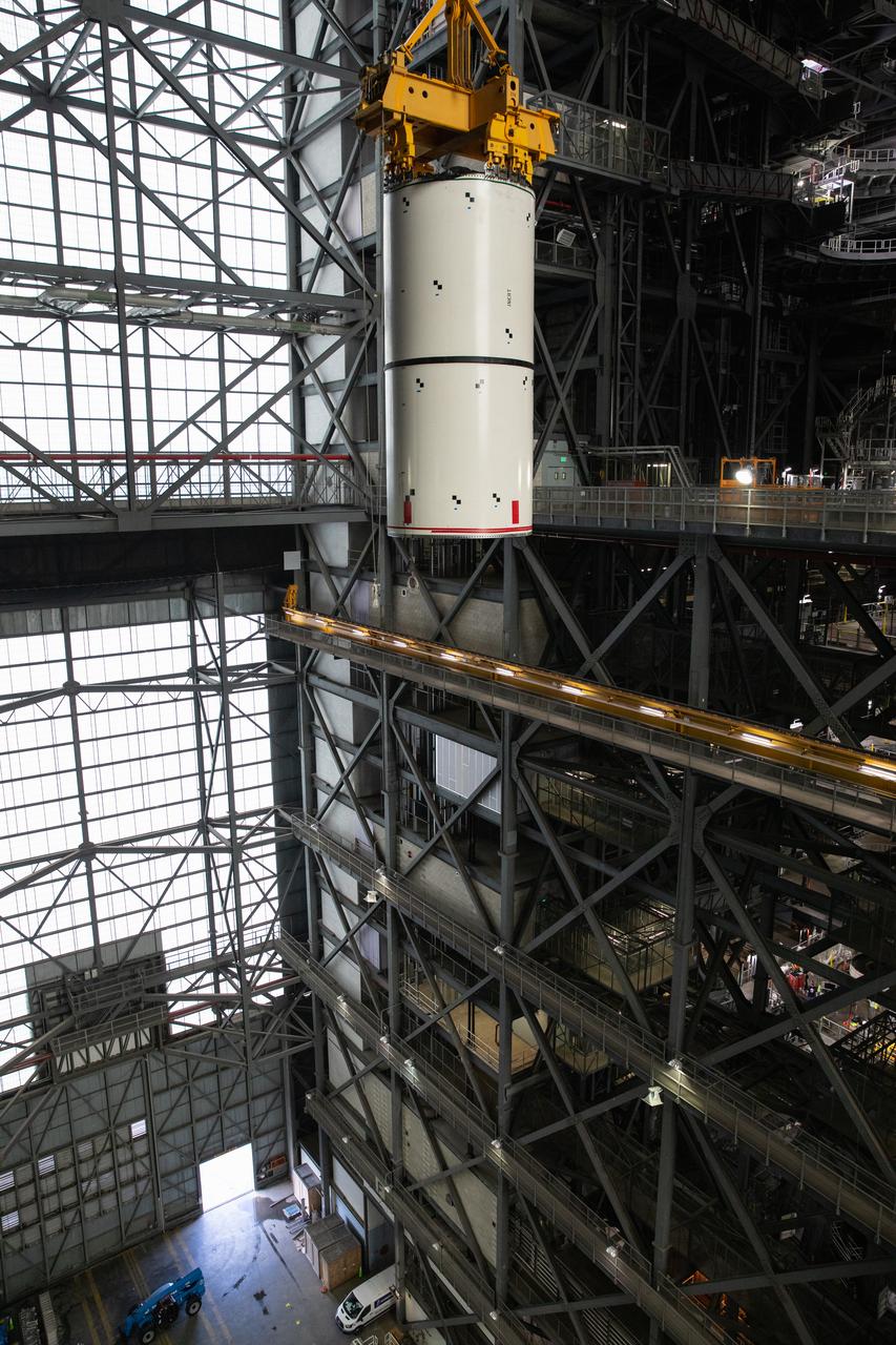 Technicians with NASA’s Exploration Ground Systems rehearse booster stacking operations inside the Vehicle Assembly Building (VAB) at the agency’s Kennedy Space Center in Florida on Sept. 14, 2020, in preparation for Artemis I. The exercise involved using booster segment mock-ups, referred to as pathfinders. During the rehearsal, an aft pathfinder segment was prepared in High Bay 4 of the VAB, after which a team of crane operators moved it over to High Bay 3, where it was placed on the mobile launcher. Careful measurements were then taken before the team added a center pathfinder to the stack. Stacking of the actual Space Launch System (SLS) booster segments will occur later this year, when the rocket’s core stage arrives at Kennedy. Artemis I is the first in a series of increasingly complex missions that will test SLS and the Orion spacecraft as an integrated system prior to crewed flights to the Moon.