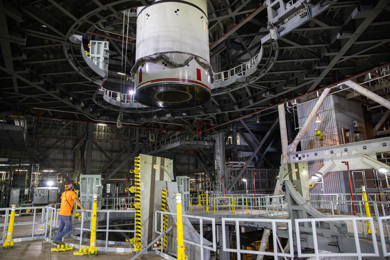 Technicians with NASA’s Exploration Ground Systems lower a mock-up, or pathfinder, of the Space Launch System’s (SLS) center booster segment onto an aft pathfinder segment inside the Vehicle Assembly Building (VAB) at the agency’s Kennedy Space Center in Florida on Sept. 14, 2020. Teams rehearsed stacking both pathfinder segments on top of the mobile launcher in High Bay 3 of the VAB in preparation for the Artemis I launch. Stacking of the actual SLS booster segments will occur later this year, when the rocket’s core stage arrives at Kennedy. Artemis I is the first in a series of increasingly complex missions that will test SLS and the Orion spacecraft as an integrated system prior to crewed flights to the Moon.