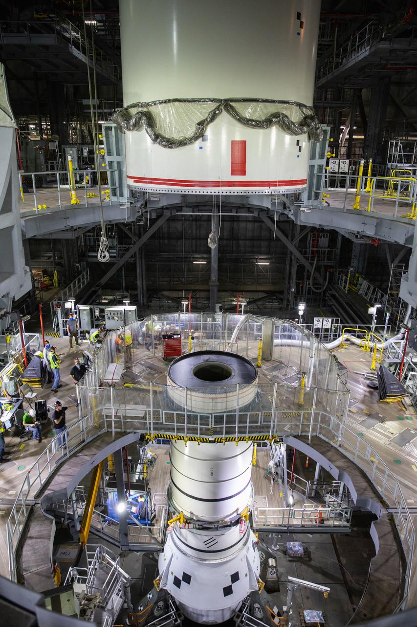 Technicians with NASA’s Exploration Ground Systems lower a mock-up, or pathfinder, of the Space Launch System’s (SLS) center booster segment onto an aft pathfinder segment inside the Vehicle Assembly Building (VAB) at the agency’s Kennedy Space Center in Florida on Sept. 14, 2020. Teams rehearsed stacking both pathfinder segments on top of the mobile launcher in High Bay 3 of the VAB in preparation for the Artemis I launch. Stacking of the actual SLS booster segments will occur later this year, when the rocket’s core stage arrives at Kennedy. Artemis I is the first in a series of increasingly complex missions that will test SLS and the Orion spacecraft as an integrated system prior to crewed flights to the Moon.