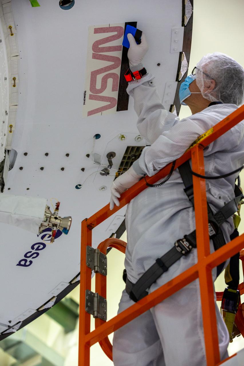 Frank Pelkey, ASRC technician, places tape around the outline of NASA’s iconic “worm” logo on the aft wall of Orion’s crew module adapter ahead of NASA’s Artemis I mission. The work is complete inside the Neil Armstrong Operations and Checkout Building high bay at Kennedy Space Center on Sept. 20, 2020. Originally created by the firm of Danne & Blackburn, the “worm” logo’s bold, sleek design was officially introduced in 1975 and was incorporated into many of the agency’s next-generation programs. It was retired in 1992, but has made a comeback in 2020 as the agency ushers in a new, modern era of human spaceflight. The first in a series of increasingly complex missions, Artemis I will test the Orion spacecraft and Space Launch System as an integrated system ahead of crewed flights to the Moon. Under the Artemis program, NASA will land the first woman and the next man on the Moon by 2024.