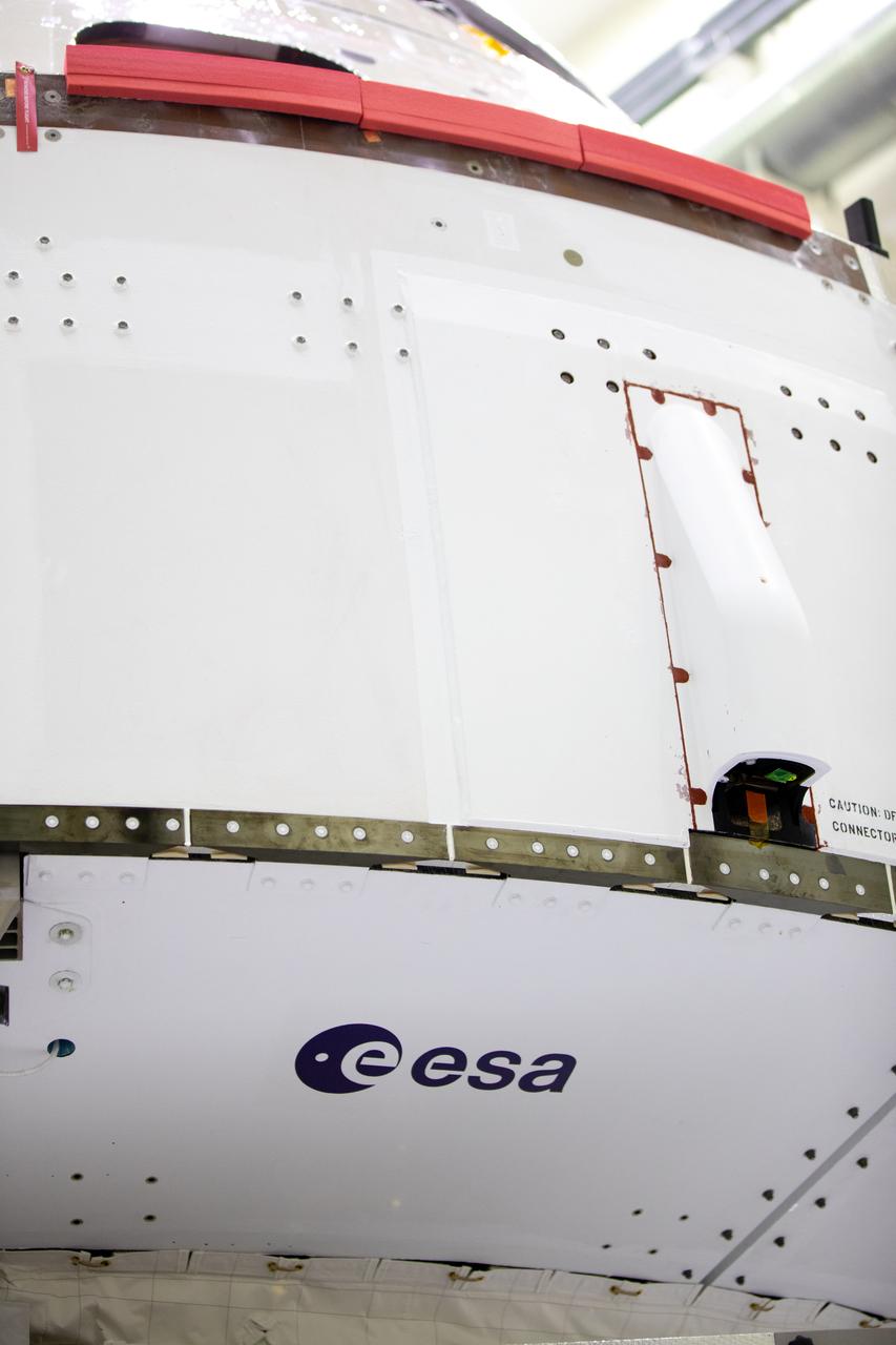 Inside the Neil Armstrong Operations and Checkout Building high bay at Kennedy Space Center, the European Space Agency (ESA) logo has been added to the aft wall of Orion’s crew module adapter ahead of NASA’s Artemis I mission. The Orion spacecraft is being prepared for installation of the solar array wings on Sept. 23, 2020. The first in a series of increasingly complex missions, Artemis I will test the Orion spacecraft and Space Launch System as an integrated system ahead of crewed flights to the Moon. Under the Artemis program, NASA will land the first woman and the next man on the Moon by 2024.