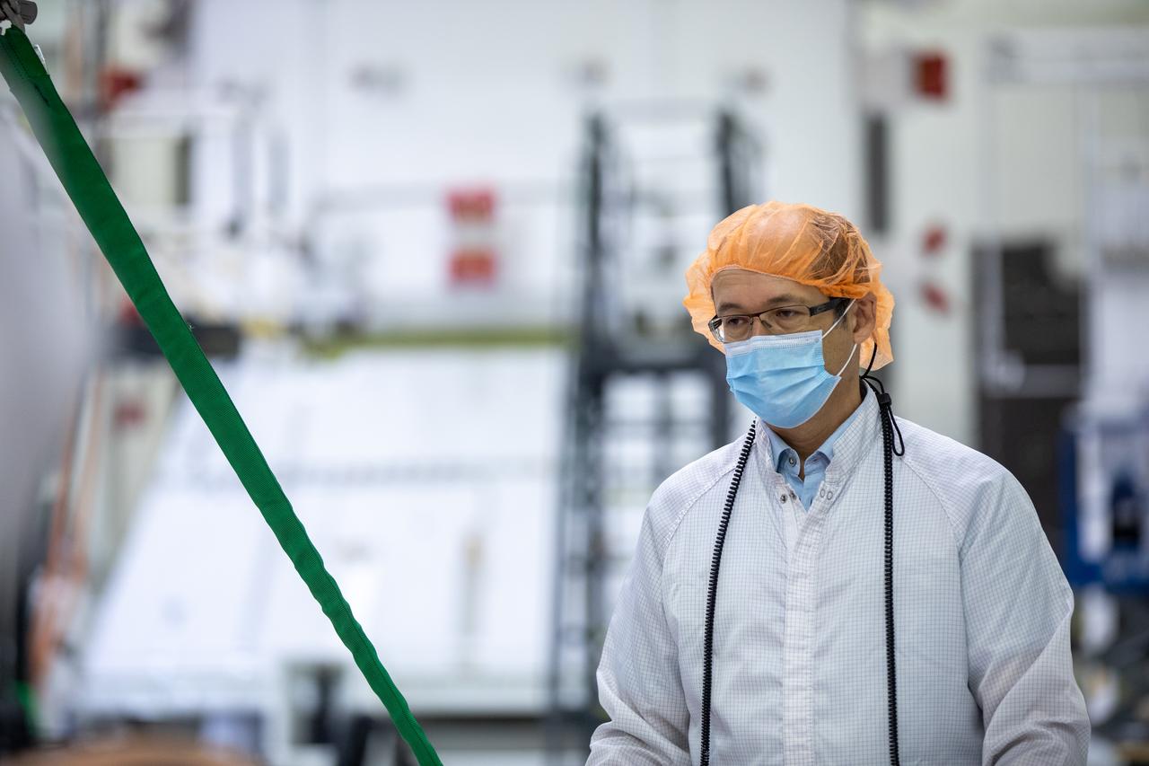Rachid Amekrane, Airbus Defence and Space Integration test director, assists with securing a protective cover as a crane prepares to lift the panel during installation of one of four solar array wings inside the Neil Armstrong Operations and Checkout Building high bay at NASA’s Kennedy Space Center in Florida on Sept. 23, 2020. The Orion spacecraft for Artemis I is shown in the background. The solar arrays were extended, inspected, and then retracted, before installation on the spacecraft. Each solar array panel will generate 11 kilowatts of power and span about 63 feet. The array is a component of Orion’s service module, which is provided by the European Space Agency and built by Airbus Defence and Space to supply Orion’s power, propulsion, air and water. The first in a series of increasingly complex missions, Artemis I will test the Orion spacecraft and Space Launch System as an integrated system ahead of crewed flights to the Moon. Under the Artemis program, NASA will land the first woman and the next man on the Moon in 2024.