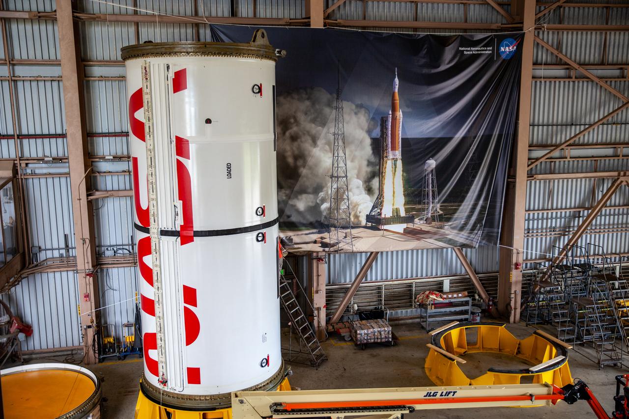 Inside the Rotation, Processing and Surge Facility at NASA’s Kennedy Space Center in Florida, Exploration Ground Systems and Jacobs TOSC workers completed painting of NASA’s iconic “worm” logo on the Artemis I Space Launch System twin solid rocket boosters on Sept. 23, 2020. Originally created by the firm of Danne & Blackburn, the iconic “worm” logo’s bold, sleek design was officially introduced in 1975 and was incorporated into many of the agency’s next-generation programs. It was retired in 1992, but has made a comeback in 2020 as the agency ushers in a new, modern era of human spaceflight. The first in a series of increasingly complex missions, Artemis I will test the Orion spacecraft and Space Launch System as an integrated system ahead of crewed flights to the Moon. Under the Artemis program, NASA will land the first woman and the next man on the Moon by 2024.