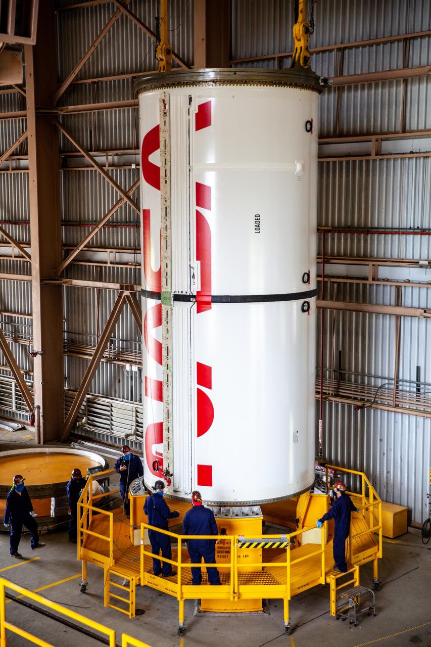 Inside the Rotation, Processing and Surge Facility at NASA’s Kennedy Space Center in Florida, Exploration Ground Systems and Jacobs TOSC workers completed painting of NASA’s iconic “worm” logo on the Artemis I Space Launch System twin solid rocket boosters on Sept. 23, 2020. Originally created by the firm of Danne & Blackburn, the iconic “worm” logo’s bold, sleek design was officially introduced in 1975 and was incorporated into many of the agency’s next-generation programs. It was retired in 1992, but has made a comeback in 2020 as the agency ushers in a new, modern era of human spaceflight. The first in a series of increasingly complex missions, Artemis I will test the Orion spacecraft and Space Launch System as an integrated system ahead of crewed flights to the Moon. Under the Artemis program, NASA will land the first woman and the next man on the Moon by 2024.