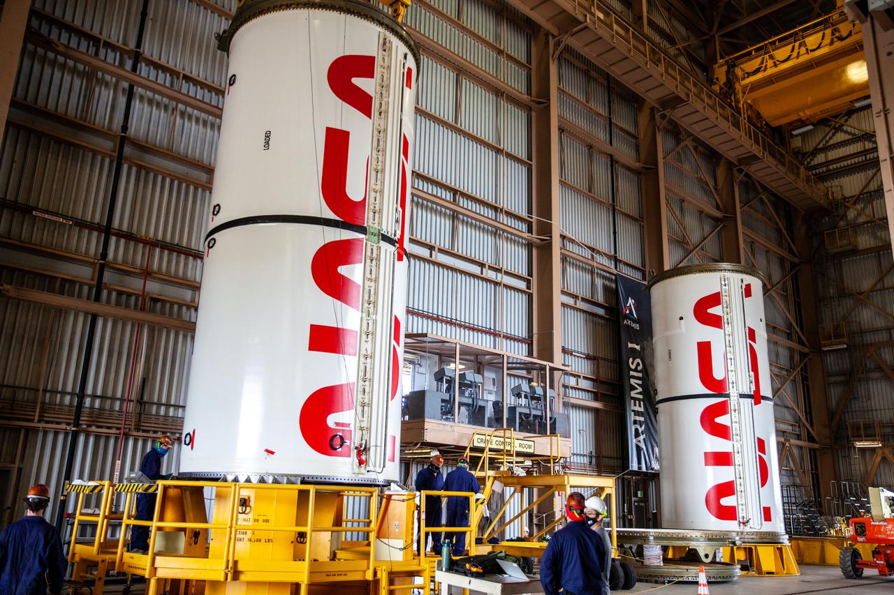 Inside the Rotation, Processing and Surge Facility at NASA’s Kennedy Space Center in Florida, Exploration Ground Systems and Jacobs TOSC workers completed painting of NASA’s iconic “worm” logo on the Artemis I Space Launch System twin solid rocket boosters on Sept. 23, 2020. Originally created by the firm of Danne & Blackburn, the iconic “worm” logo’s bold, sleek design was officially introduced in 1975 and was incorporated into many of the agency’s next-generation programs. It was retired in 1992, but has made a comeback in 2020 as the agency ushers in a new, modern era of human spaceflight. The first in a series of increasingly complex missions, Artemis I will test the Orion spacecraft and Space Launch System as an integrated system ahead of crewed flights to the Moon. Under the Artemis program, NASA will land the first woman and the next man on the Moon by 2024.