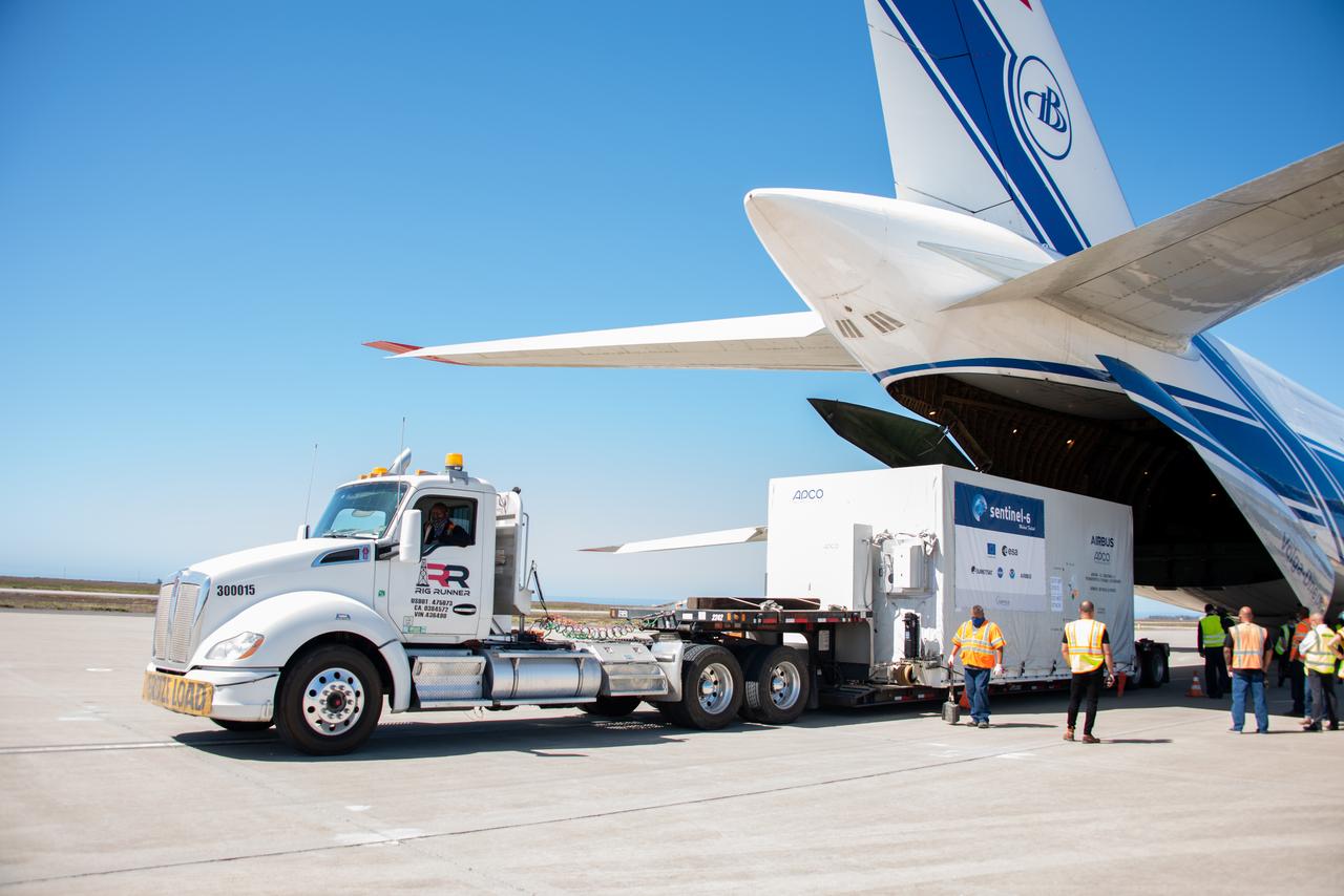 The Sentinel-6 Michael Freilich satellite, secured inside a shipping container, is placed on a transport vehicle after the spacecraft’s arrival at Vandenberg Air Force Base in California aboard a Antonov cargo aircraft, Sept. 24, 2020. The mission is an international partnership and the first launch of a constellation of two satellites that will observe changes in Earth’s sea levels for at least the next decade. Launching atop a SpaceX Falcon 9 rocket, Sentinel-6 Michael Freilich is targeted to lift off from Vandenberg’s Space Launch Complex 4 on Nov. 10, 2020. The Launch Services Program at Kennedy is responsible for launch management.