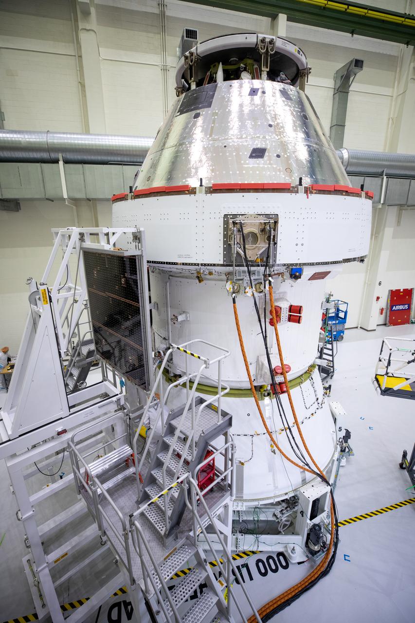 Shown is one of four solar array wings being fitted onto the Orion spacecraft for Artemis I inside the Neil Armstrong Operations and Checkout Building high bay at NASA’s Kennedy Space Center in Florida on Sept. 25, 2020. The solar arrays were extended, inspected, and then retracted before installation on the spacecraft. Each of the four solar array panels will generate 11 kilowatts of power and span about 63 feet. The array is a component of Orion’s service module, which is provided by the European Space Agency and built by Airbus Defence and Space to supply Orion’s power, propulsion, air, and water. The first in a series of increasingly complex missions, Artemis I will test the Orion spacecraft and Space Launch System as an integrated system ahead of crewed flights to the Moon. Under the Artemis program, NASA will land the first woman and the next man on the Moon in 2024. 