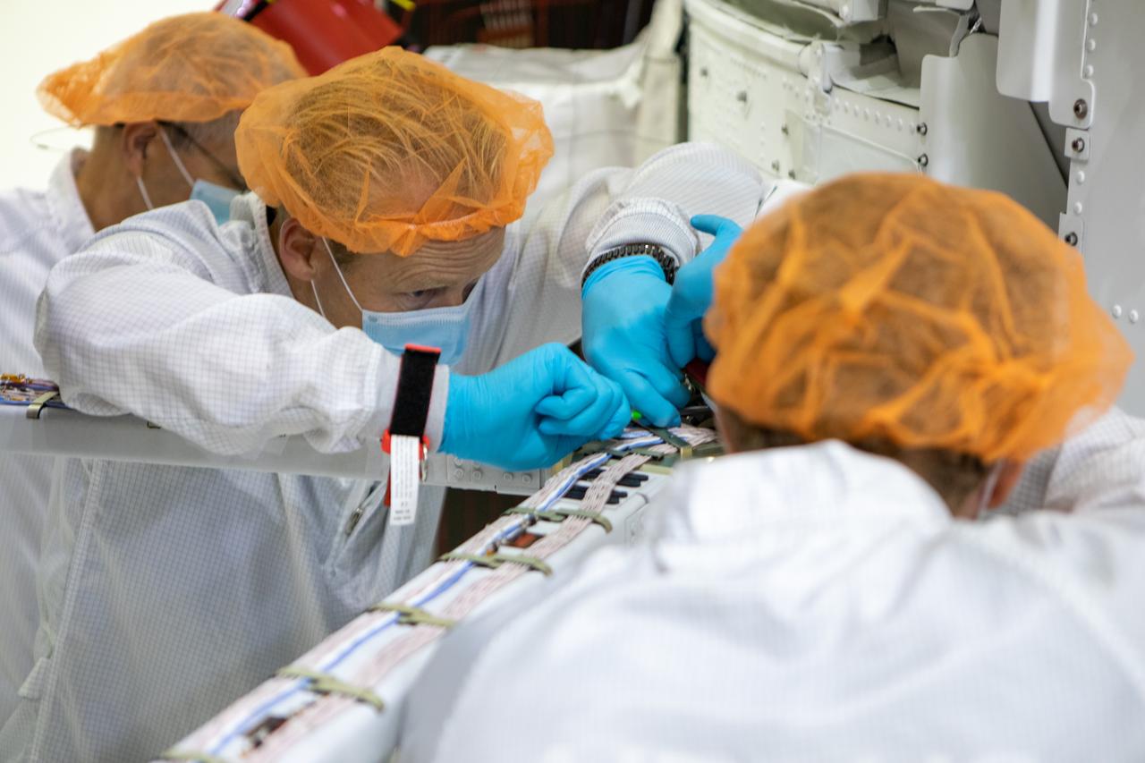 Members of the European Service Module processing team from the European Space Agency (ESA), Airbus, and Airbus Netherlands install the four solar array wings on the Orion spacecraft for Artemis I inside the Neil Armstrong Operations and Checkout Building high bay at NASA’s Kennedy Space Center in Florida on Sept. 25, 2020. The solar arrays were extended, inspected, and then retracted before installation on the spacecraft. Each solar array panel will generate 11 kilowatts of power and span about 63 feet. The array is a component of Orion’s service module, which is provided by ESA and built by Airbus Defence and Space to supply Orion’s power, propulsion, air, and water. The first in a series of increasingly complex missions, Artemis I will test the Orion spacecraft and Space Launch System as an integrated system ahead of crewed flights to the Moon. Under the Artemis program, NASA will land the first woman and the next man on the Moon in 2024.