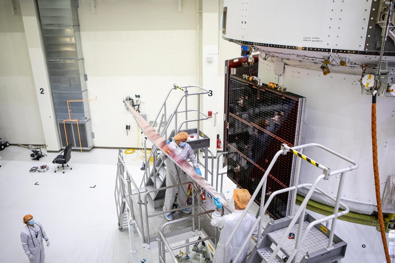 Members of the European Service Module processing team from the European Space Agency (ESA), Airbus, and Airbus Netherlands fit a protective cover over the solar array wings on the Orion spacecraft for Artemis I inside the Neil Armstrong Operations and Checkout Building high bay at NASA’s Kennedy Space Center in Florida on Sept. 25, 2020. The solar arrays were extended, inspected, and then retracted before installation on the spacecraft. Each solar array panel will generate 11 kilowatts of power and span about 63 feet. The array is a component of Orion’s service module, which is provided by ESA and built by Airbus Defence and Space to supply Orion’s power, propulsion, air, and water. The first in a series of increasingly complex missions, Artemis I will test the Orion spacecraft and Space Launch System as an integrated system ahead of crewed flights to the Moon. Under the Artemis program, NASA will land the first woman and the next man on the Moon in 2024.