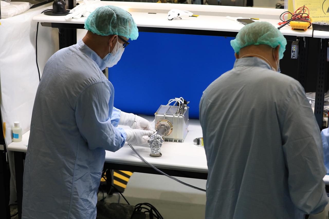 Engineers and technicians at NASA’s Kennedy Space Center in Florida work with instruments for Mass Spectrometer observing lunar operations (MSolo) inside the Space Station Processing on Sept. 25, 2020. MSolo is a commercial off-the-shelf mass spectrometer modified to work in space and it will help analyze the chemical makeup of landing sites on the Moon, as well as study water on the lunar surface. This work is preparing MSolo hardware for a robotic mission as part of the Commercial Lunar Payload Services (CLPS) launching to exploring Lacus Mortis, a large crater on the near side of the Moon in 2021. A future mission will send a mobile robot named the Volatiles Investigating Polar Exploration Rover (VIPER) to the Moon to prospect for water. VIPER will have several instruments that will allow it to detect and sample water including MSolo, the Neutron Spectrometer System, the Near Infrared Volatiles Spectrometer System and The Regolith and Ice Drill for Exploring New Terrain (TRIDENT).