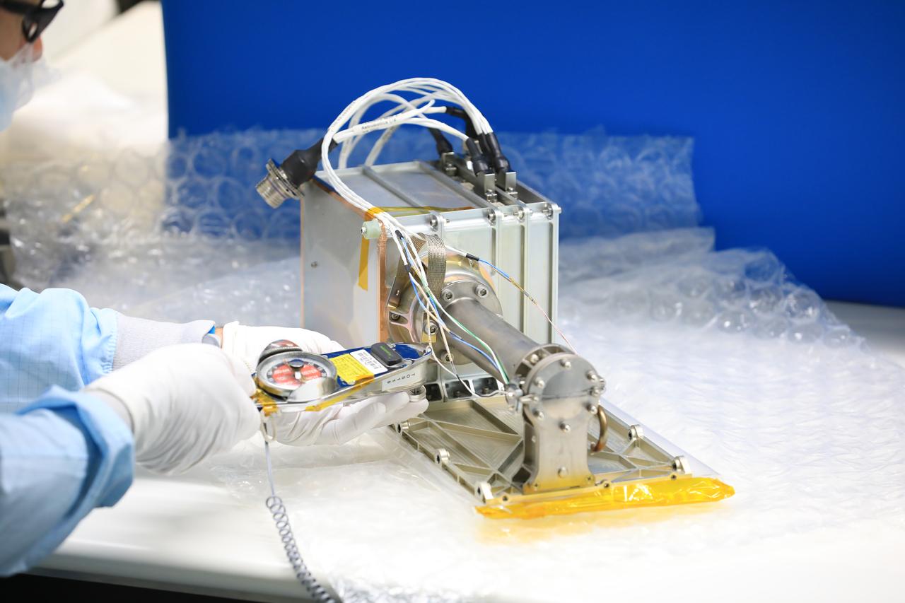 Engineers and technicians at NASA’s Kennedy Space Center in Florida install the radiator for the Mass Spectrometer Observing Lunar Operations (MSolo) instrument inside the Space Station Processing Facility on Sept. 25, 2020. MSolo will help analyze the chemical makeup of landing sites on the Moon, as well as study water on the lunar surface. The radiator will help keep the instrument’s temperature stable in the extreme heat and cold it will encounter. MSolo instruments are scheduled to launch on multiple robotic missions as part of NASA’s Commercial Lunar Payload Services (CLPS), with the first of these missions exploring Lacus Mortis, a large crater on the near side of the Moon, beginning in 2021. MSolo also will be one of three instruments on the agency’s water-hunting Volatiles Investigating Polar Exploration Rover, VIPER, scheduled to launch to the Moon’s South Pole in late 2023.