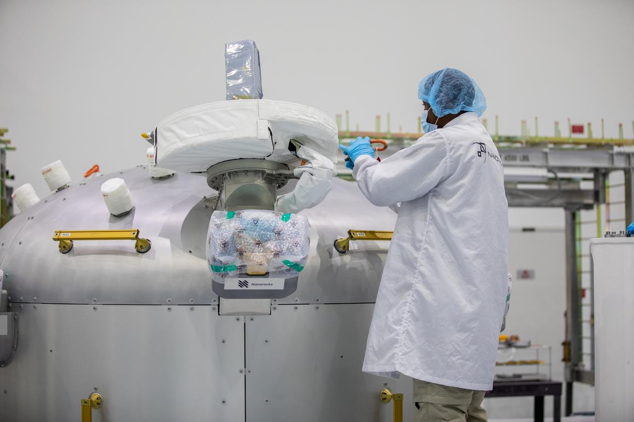 A Nanoracks technician works on the Nanoracks Bishop Airlock inside the Space Station Processing Facility at NASA's Kennedy Space Center in Florida on Sept. 29, 2020. The next-generation Nanoracks payload facility is being prepared for its flight to the International Space Station on SpaceX’s 21st commercial resupply services mission (CRS-21) to the International Space Station. The Bishop Airlock is the first commercially funded airlock for the space station. It will provide payload hosting, robotics testing, satellite deployment, and serve as an outside toolbox for station crew spacewalks, and more. CRS-21 is scheduled to launch on a SpaceX Falcon 9 rocket no earlier than November from Launch Complex 39A at Kennedy Space Center.