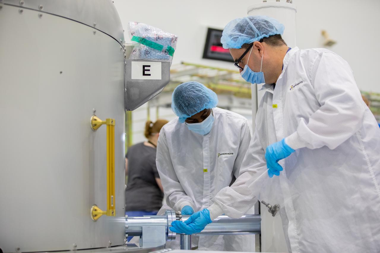 Nanoracks technicians work on the NanoRacks Bishop Airlock inside the Space Station Processing Facility at NASA's Kennedy Space Center in Florida on Sept. 29, 2020. The next-generation Nanoracks payload facility is being prepared for its flight to the International Space Station on SpaceX’s 21st commercial resupply services mission (CRS-21) to the International Space Station. The Bishop Airlock is the first commercially funded airlock for the space station. It will provide payload hosting, robotics testing, satellite deployment, serve as an outside toolbox for station crew spacewalks, and more. CRS-21 is scheduled to launch on a SpaceX Falcon 9 rocket no earlier than November from Launch Complex 39A at Kennedy Space Center.