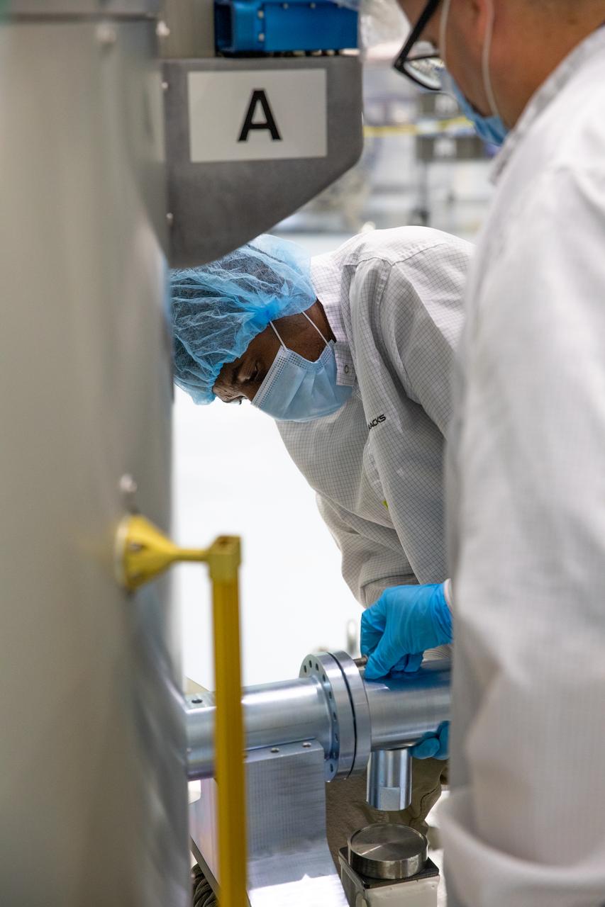 Nanoracks technicians work on the NanoRacks Bishop Airlock inside the Space Station Processing Facility at NASA's Kennedy Space Center in Florida on Sept. 29, 2020. The next-generation Nanoracks payload facility is being prepared for its flight to the International Space Station on SpaceX’s 21st commercial resupply services mission (CRS-21) to the International Space Station. The Bishop Airlock is the first commercially funded airlock for the space station. It will provide payload hosting, robotics testing, satellite deployment, serve as an outside toolbox for station crew spacewalks, and more. CRS-21 is scheduled to launch on a SpaceX Falcon 9 rocket no earlier than November from Launch Complex 39A at Kennedy Space Center.