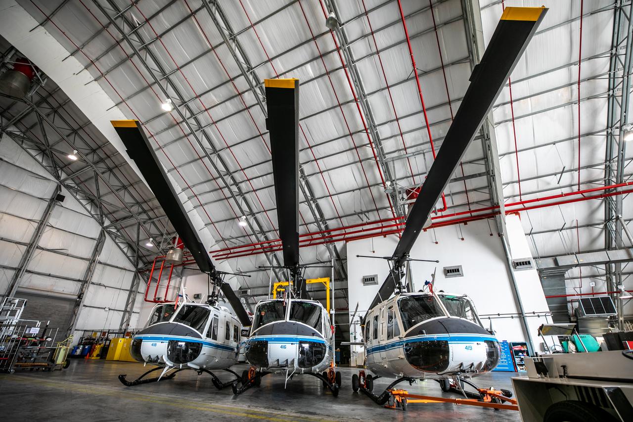 The three Bell Huey 2 helicopters utilized by Kennedy Space Center’s Flight Operations team for security purposes are photographed inside the Launch and Landing Facility hangar on Sept. 30, 2020. Two new Airbus H135 (T3) helicopters arrived at the Florida spaceport on Sept. 30 to replace the Bell Huey 2 aircraft in service now. The new helicopters provide a number of technological and safety advantages over the Hueys, such as more lifting power, greater stability in the air, and expanded medical capabilities. The team expects to fully transition to flying the two H135 aircraft later this year. A third is expected to arrive in early 2021, and with its arrival, will complete the fleet’s upgrade.