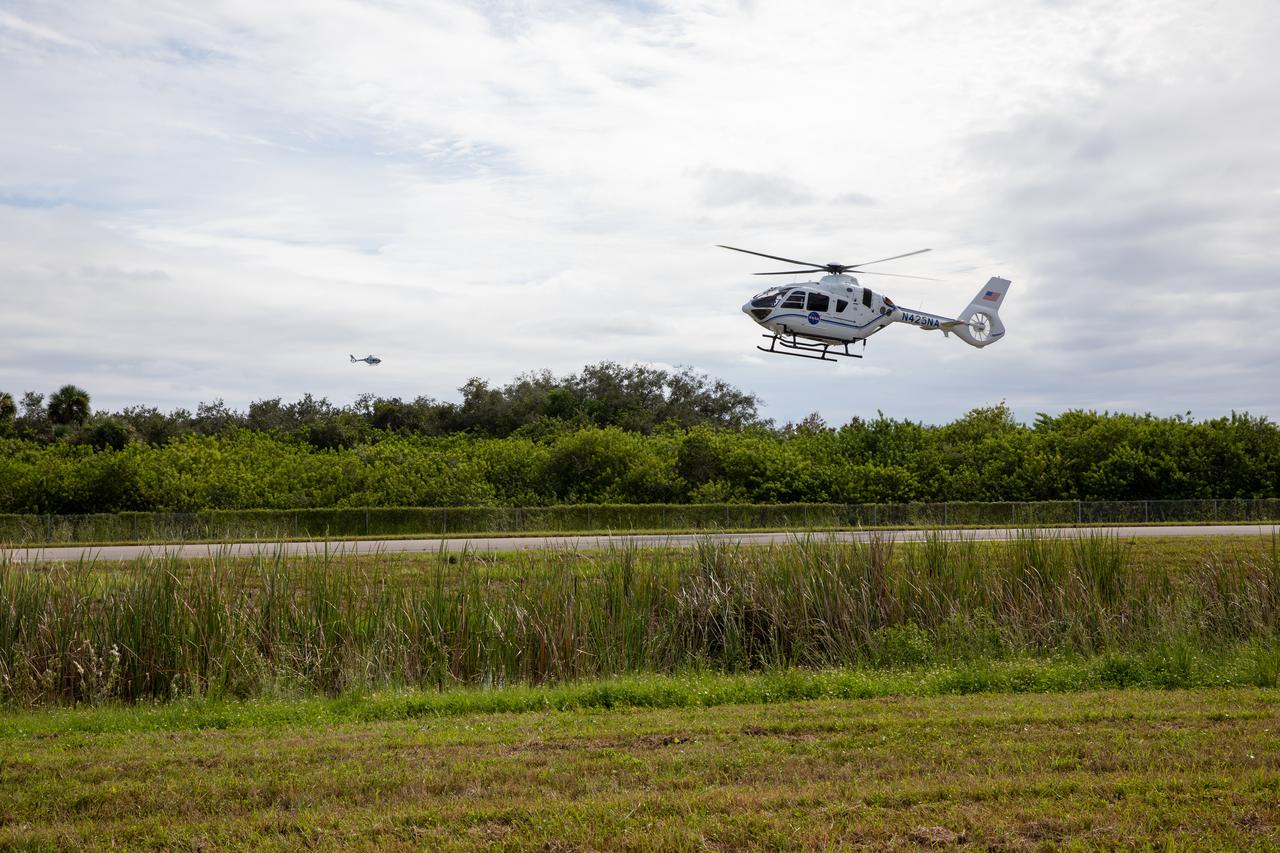 A new Airbus H135 (T3) helicopter arrives at the Launch and Landing Facility runway at NASA’s Kennedy Space Center in Florida on Sept. 30, 2020. In the distance, a second one can be seen arriving. The two H135 helicopters will replace the Bell Huey 2 security aircraft in service now, maintained by Kennedy’s Flight Operations team. These new helicopters provide a number of technological and safety advantages over the Hueys, such as more lifting power, greater stability in the air, and expanded medical capabilities. The team expects to fully transition to flying the two H135s later this year. A third is expected to arrive in early 2021, and with its arrival, will complete the fleet’s upgrade.