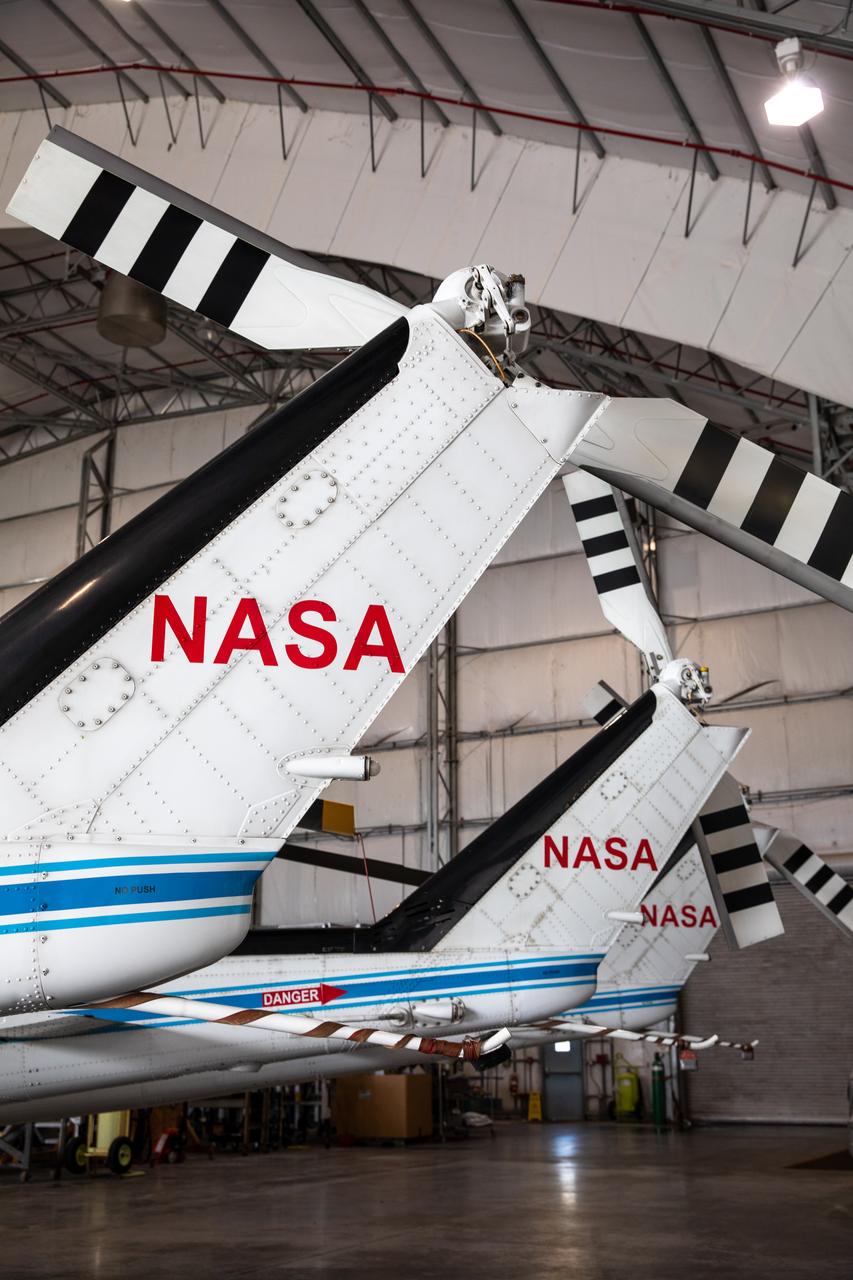 The three Bell Huey 2 helicopters utilized by Kennedy Space Center’s Flight Operations team for security purposes are photographed inside the Launch and Landing Facility hangar on Sept. 30, 2020. Two new Airbus H135 (T3) helicopters arrived at the Florida spaceport on Sept. 30 to replace the Bell Huey 2 aircraft in service now. The new helicopters provide a number of technological and safety advantages over the Hueys, such as more lifting power, greater stability in the air, and expanded medical capabilities. The team expects to fully transition to flying the two H135 aircraft later this year. A third is expected to arrive in early 2021, and with its arrival, will complete the fleet’s upgrade.