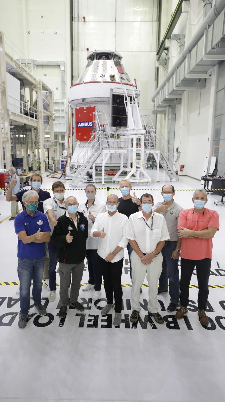 Members of the European Service Module processing team from the European Space Agency, Airbus, and Airbus Netherlands are shown with Orion’s solar array wings installed on the spacecraft for Artemis I inside the Neil Armstrong Operations and Checkout Building high bay at NASA’s Kennedy Space Center in Florida on Sept. 30, 2020. The solar arrays were extended, inspected, and then retracted, before installation on the spacecraft. Each solar array panel will generate 11 kilowatts of power and span about 63 feet. The array is a component of Orion’s service module, which is provided by the European Space Agency and built by Airbus Defence and Space to supply Orion’s power, propulsion, air and water. The first in a series of increasingly complex missions, Artemis I will test the Orion spacecraft and Space Launch System as an integrated system ahead of crewed flights to the Moon. Under the Artemis program, NASA will land the first woman and the next man on the Moon in 2024.