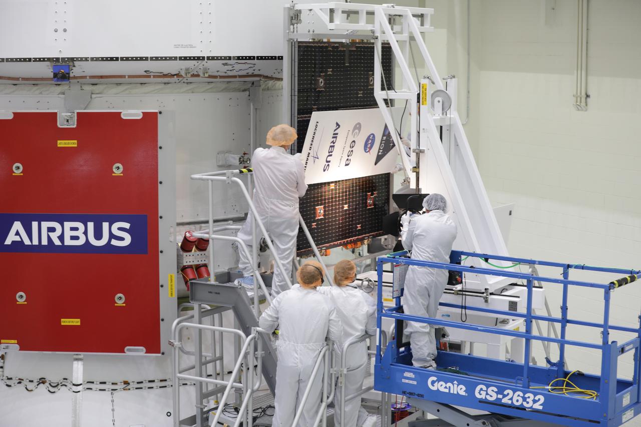 Technicians with the European Space Agency and Airbus/Airbus Netherlands are shown performing an illumination test on one of the solar array wing panels during installation on the Orion spacecraft for Artemis I inside the Neil Armstrong Operations and Checkout Building high bay at NASA’s Kennedy Space Center in Florida on Sept. 30, 2020. The solar arrays were extended, inspected, and then retracted, before installation on the spacecraft. Each solar array panel will generate 11 kilowatts of power and span about 63 feet. The array is a component of Orion’s service module, which is provided by the European Space Agency and built by Airbus Defence and Space to supply Orion’s power, propulsion, air and water. The first in a series of increasingly complex missions, Artemis I will test the Orion spacecraft and Space Launch System as an integrated system ahead of crewed flights to the Moon. Under the Artemis program, NASA will land the first woman and the next man on the Moon in 2024.