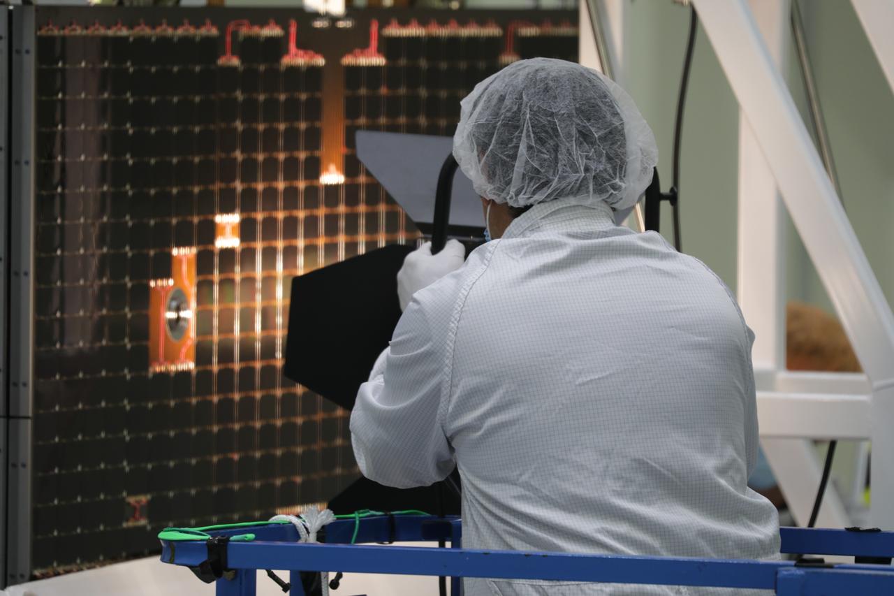 A Lockheed Martin technician is shown assisting with lighting one of the solar array wing panels as part of an illumination test during installation on the Orion spacecraft for Artemis I inside the Neil Armstrong Operations and Checkout Building high bay at NASA’s Kennedy Space Center in Florida on Sept. 30, 2020. The solar arrays were extended, inspected, and then retracted, before installation on the spacecraft. Each solar array panel will generate 11 kilowatts of power and span about 63 feet. The array is a component of Orion’s service module, which is provided by the European Space Agency and built by Airbus Defence and Space to supply Orion’s power, propulsion, air and water. The first in a series of increasingly complex missions, Artemis I will test the Orion spacecraft and Space Launch System as an integrated system ahead of crewed flights to the Moon. Under the Artemis program, NASA will land the first woman and the next man on the Moon in 2024.
