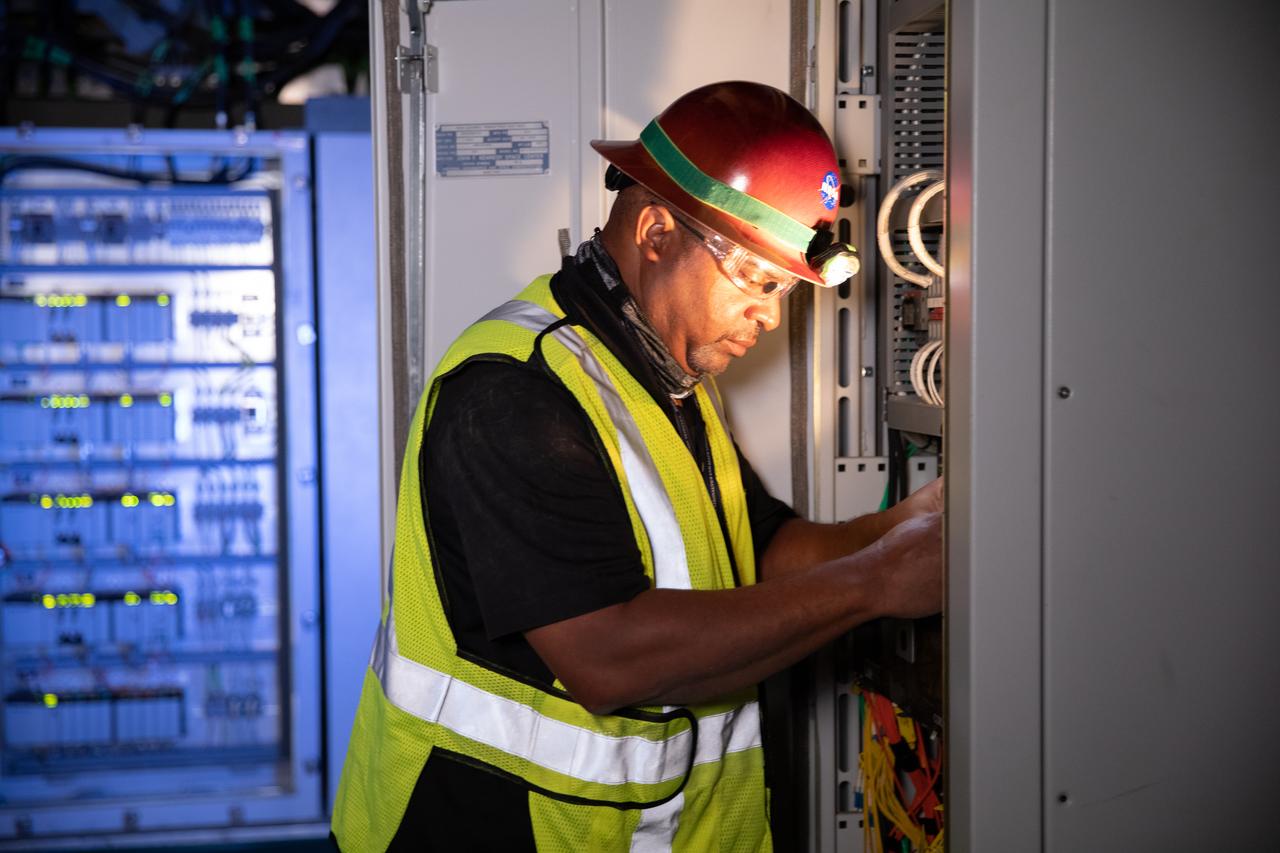 Reggie Martin, an engineer with Exploration Ground Systems, works on racks inside the mobile launcher at NASA’s Kennedy Space Center in Florida on Oct. 2, 2020. Software engineers are writing and testing new software for launch of the Space Launch System and Orion spacecraft for Artemis I.