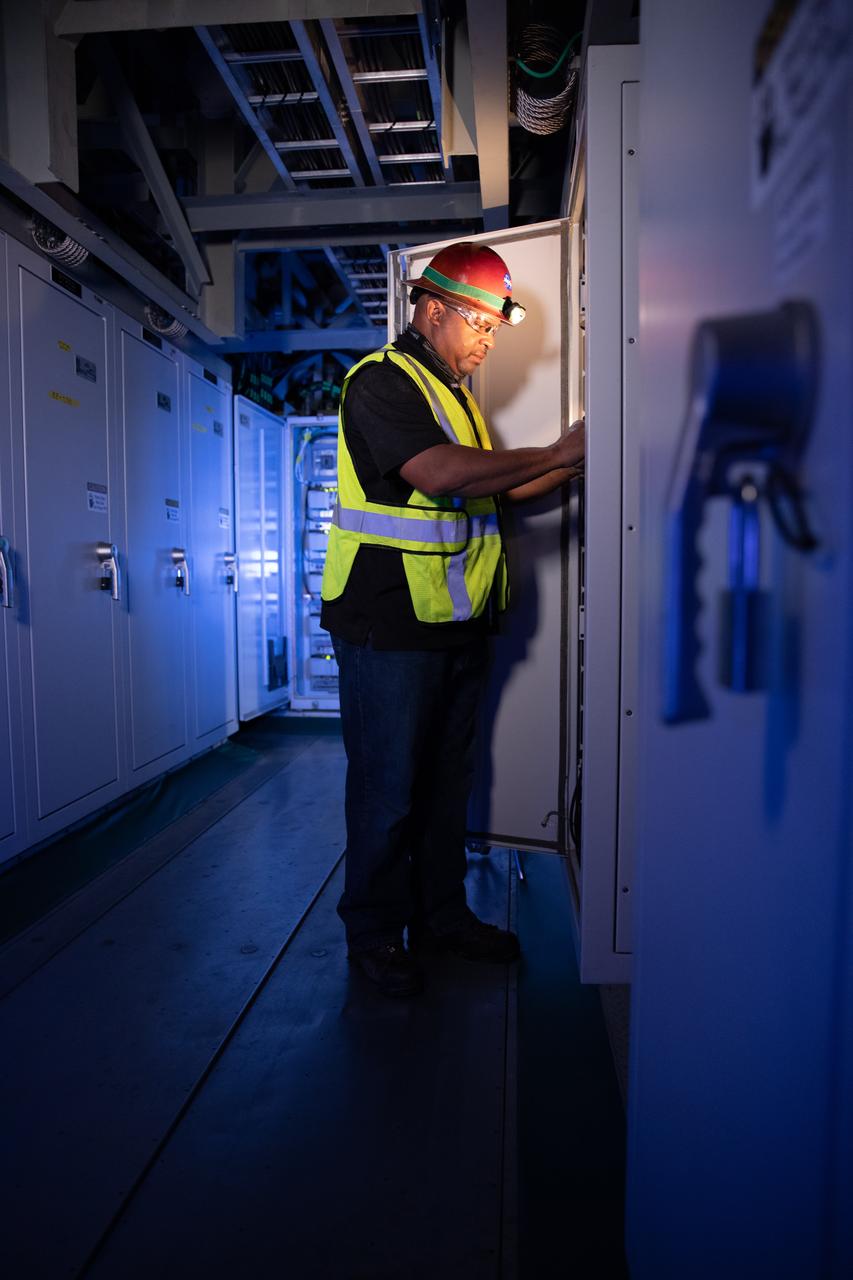 Reggie Martin, an engineer with Exploration Ground Systems, works on racks inside the mobile launcher at NASA’s Kennedy Space Center in Florida on Oct. 2, 2020. Software engineers are writing and testing new software for launch of the Space Launch System and Orion spacecraft for Artemis I.