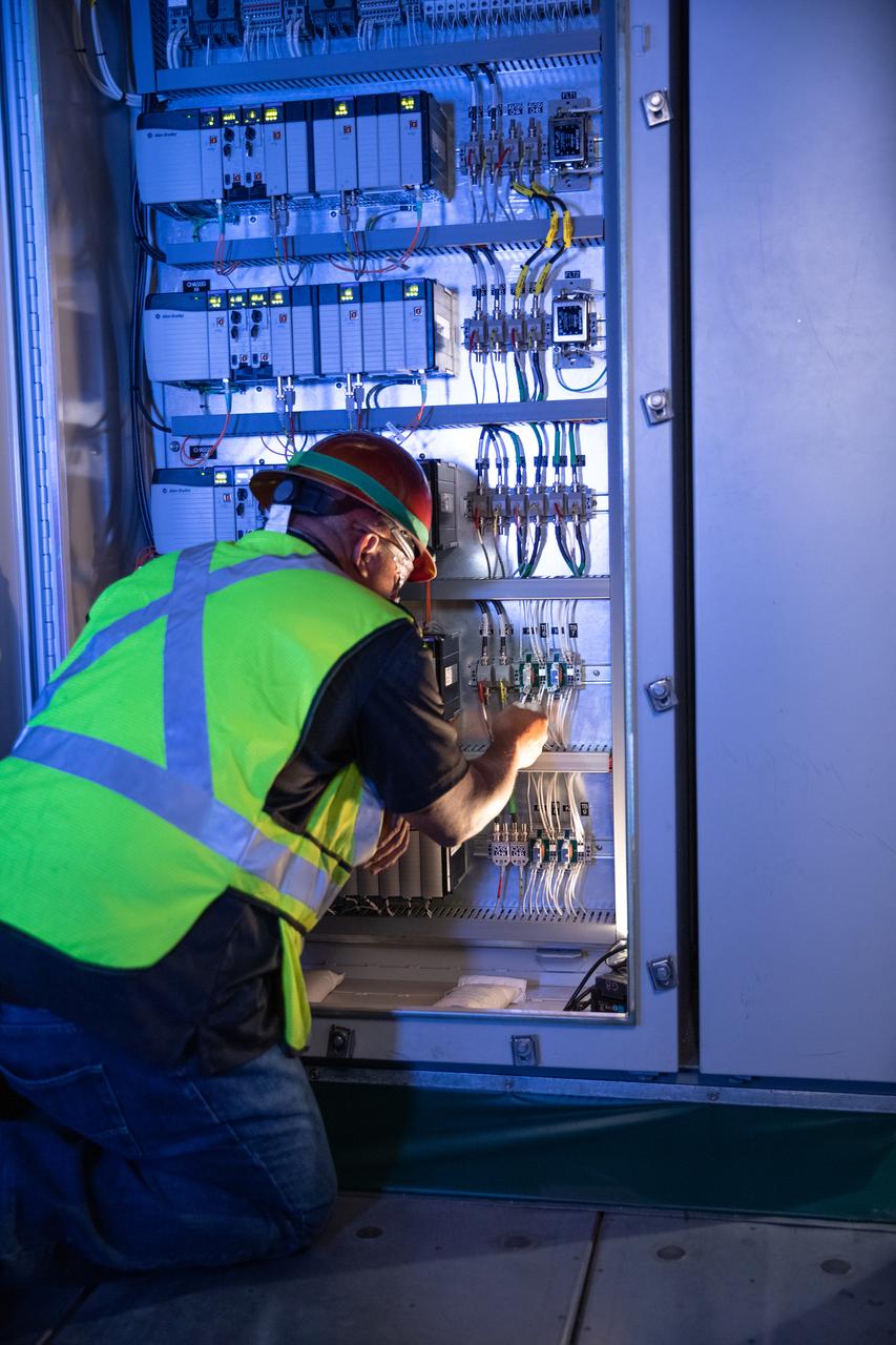 Reggie Martin, an engineer with Exploration Ground Systems, works on racks inside the mobile launcher at NASA’s Kennedy Space Center in Florida on Oct. 2, 2020. Software engineers are writing and testing new software for launch of the Space Launch System and Orion spacecraft for Artemis I.