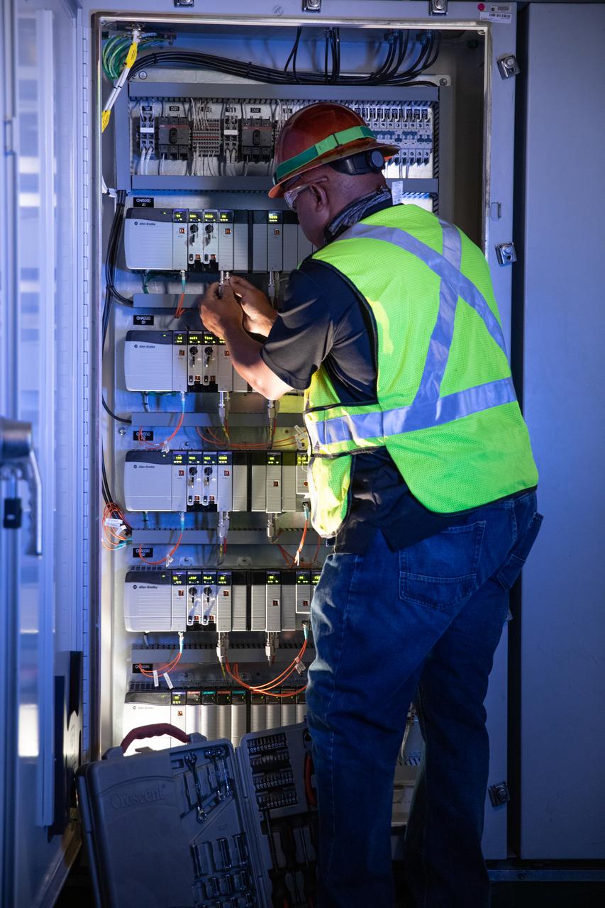 Reggie Martin, an engineer with Exploration Ground Systems, works on racks inside the mobile launcher at NASA’s Kennedy Space Center in Florida on Oct. 2, 2020. Software engineers are writing and testing new software for launch of the Space Launch System and Orion spacecraft for Artemis I.
