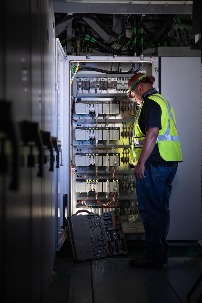 Reggie Martin, an engineer with Exploration Ground Systems, works on racks inside the mobile launcher at NASA’s Kennedy Space Center in Florida on Oct. 2, 2020. Software engineers are writing and testing new software for launch of the Space Launch System and Orion spacecraft for Artemis I.