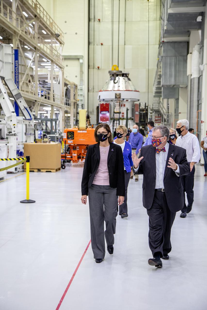 Catherine Koerner, in front at left, NASA Orion Program manager, along with senior managers from Orion and Lockheed Martin, tour the Neil Armstrong Operations and Checkout Building at NASA’s Kennedy Space Center in Florida on Oct. 6, 2020. Accompanying her, in front at right is Mike Hawes, Lockheed Martin vice president and Orion Program manager. In view behind Koerner is Annette Hasbrook, Orion Program assistant manager. In view behind Hawes is Scott Wilson, NASA Kennedy Orion Production Operations manager. Koerner viewed Orion spacecraft for the Artemis I, shown in the background, and II missions. The first in a series of increasingly complex missions, Artemis I will test the Orion spacecraft and Space Launch System as an integrated system ahead of crewed flights to the Moon. Under the Artemis program, NASA will land the first woman and the next man on the Moon in 2024.