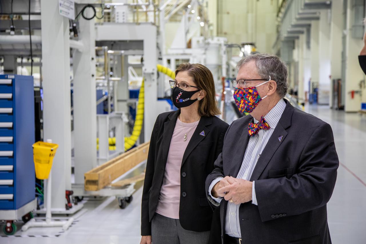 Catherine Koerner, at left, NASA Orion Program manager, along with senior managers from Orion and Lockheed Martin, tours the Neil Armstrong Operations and Checkout Building at NASA’s Kennedy Space Center in Florida on Oct. 6, 2020. Accompanying her, at right is Mike Hawes, Lockheed Martin vice president and Orion Program manager. Koerner viewed Orion spacecraft for the Artemis I and II missions. The first in a series of increasingly complex missions, Artemis I will test the Orion spacecraft and Space Launch System as an integrated system ahead of crewed flights to the Moon. Under the Artemis program, NASA will land the first woman and the next man on the Moon in 2024.