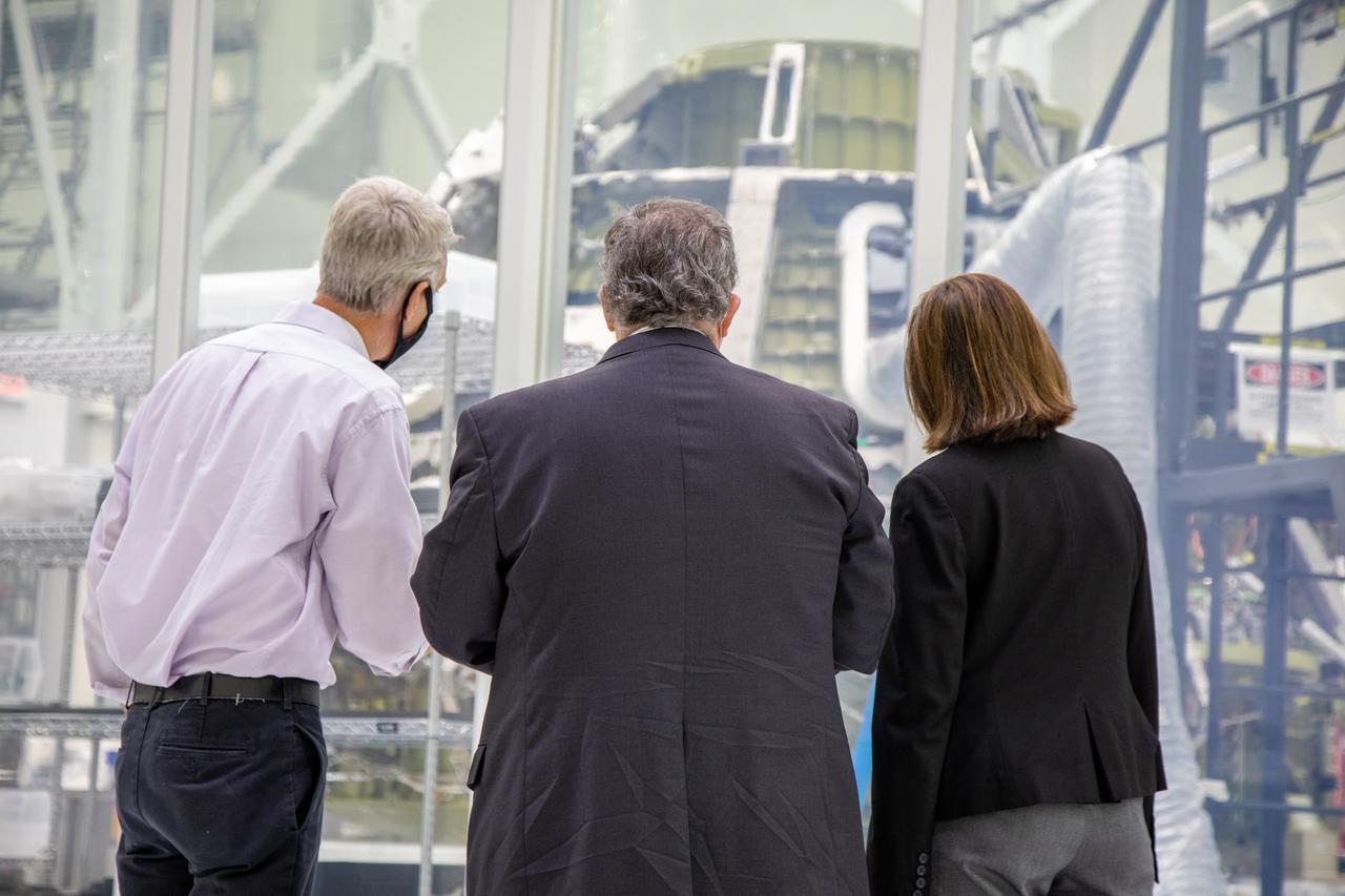 Catherine Koerner, at far right, NASA Orion Program manager, along with senior managers from Orion and Lockheed Martin, tours the Neil Armstrong Operations and Checkout Building at NASA’s Kennedy Space Center in Florida on Oct. 6, 2020. Accompanying her, from left are Scott Wilson, NASA Kennedy Orion Production Operations manager, and Mike Hawes, Lockheed Martin vice president and Orion Program manager. They are pictured viewing the Orion crew module for the Artemis II mission, and also viewed the Orion spacecraft with its solar array wings installed for Artemis I. The first in a series of increasingly complex missions, Artemis I will test the Orion spacecraft and Space Launch System as an integrated system ahead of crewed flights to the Moon. Under the Artemis program, NASA will land the first woman and the next man on the Moon in 2024.
