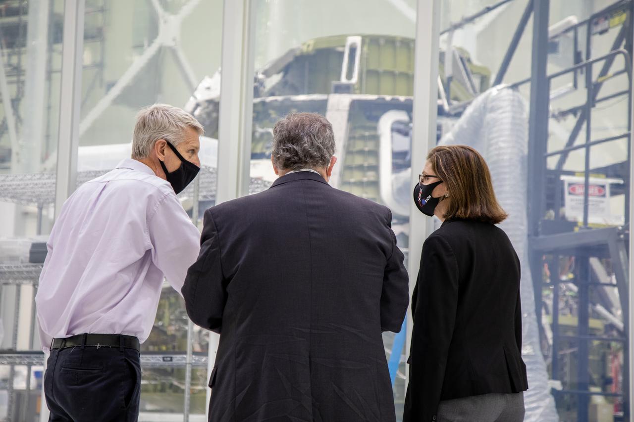 Catherine Koerner, at far right, NASA Orion Program manager, along with senior managers from Orion and Lockheed Martin, tours the Neil Armstrong Operations and Checkout Building at NASA’s Kennedy Space Center in Florida on Oct. 6, 2020. Accompanying her, from left are Scott Wilson, NASA Kennedy Orion Production Operations manager, and Mike Hawes, Lockheed Martin vice president and Orion Program manager. They are pictured viewing the Orion crew module for the Artemis II mission, and also viewed the Orion spacecraft with its solar array wings installed for Artemis I. The first in a series of increasingly complex missions, Artemis I will test the Orion spacecraft and Space Launch System as an integrated system ahead of crewed flights to the Moon. Under the Artemis program, NASA will land the first woman and the next man on the Moon in 2024.