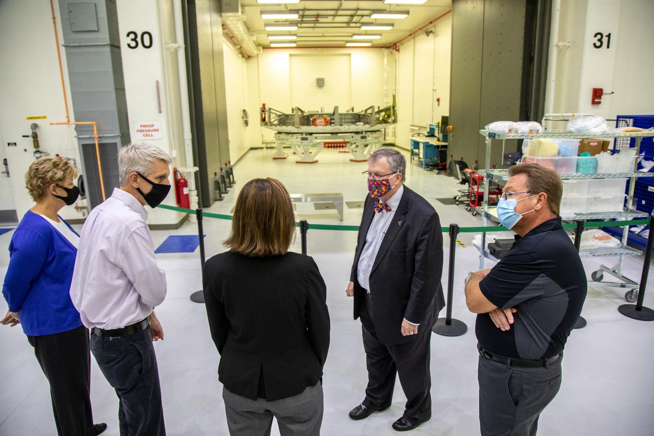Catherine Koerner, in the center, NASA Orion Program manager, along with senior managers from Orion and Lockheed Martin, tours the Neil Armstrong Operations and Checkout Building at NASA’s Kennedy Space Center in Florida on Oct. 6, 2020. Accompanying her, from left are Annette Hasbrook, Orion Program assistant manager; Scott Wilson, NASA Kennedy Orion Production Operations manager, Mike Hawes, Lockheed Martin vice president and Orion Program manager; and Jules Schneider, Lockheed Martin Assembly, Test and Launch Operations director with Lockheed Martin. Koerner viewed the Orion spacecraft for the Artemis I and II missions. They are shown with the crew module adapter for the Orion Artemis II mission. The first in a series of increasingly complex missions, Artemis I will test the Orion spacecraft and Space Launch System as an integrated system ahead of crewed flights to the Moon. Under the Artemis program, NASA will land the first woman and the next man on the Moon in 2024.