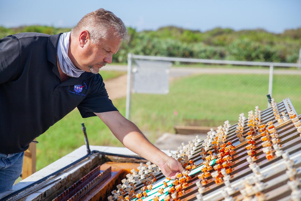 A Mechanical and Environmental Testing Lab engineer examines samples at the corrosion engineering test site on Oct. 6, 2020, at NASA’s Kennedy Space Center in Florida. The corrosion lab is a network of people, equipment, and facilities that provides engineering services and technical innovations in all areas of corrosion for NASA and external customers.
