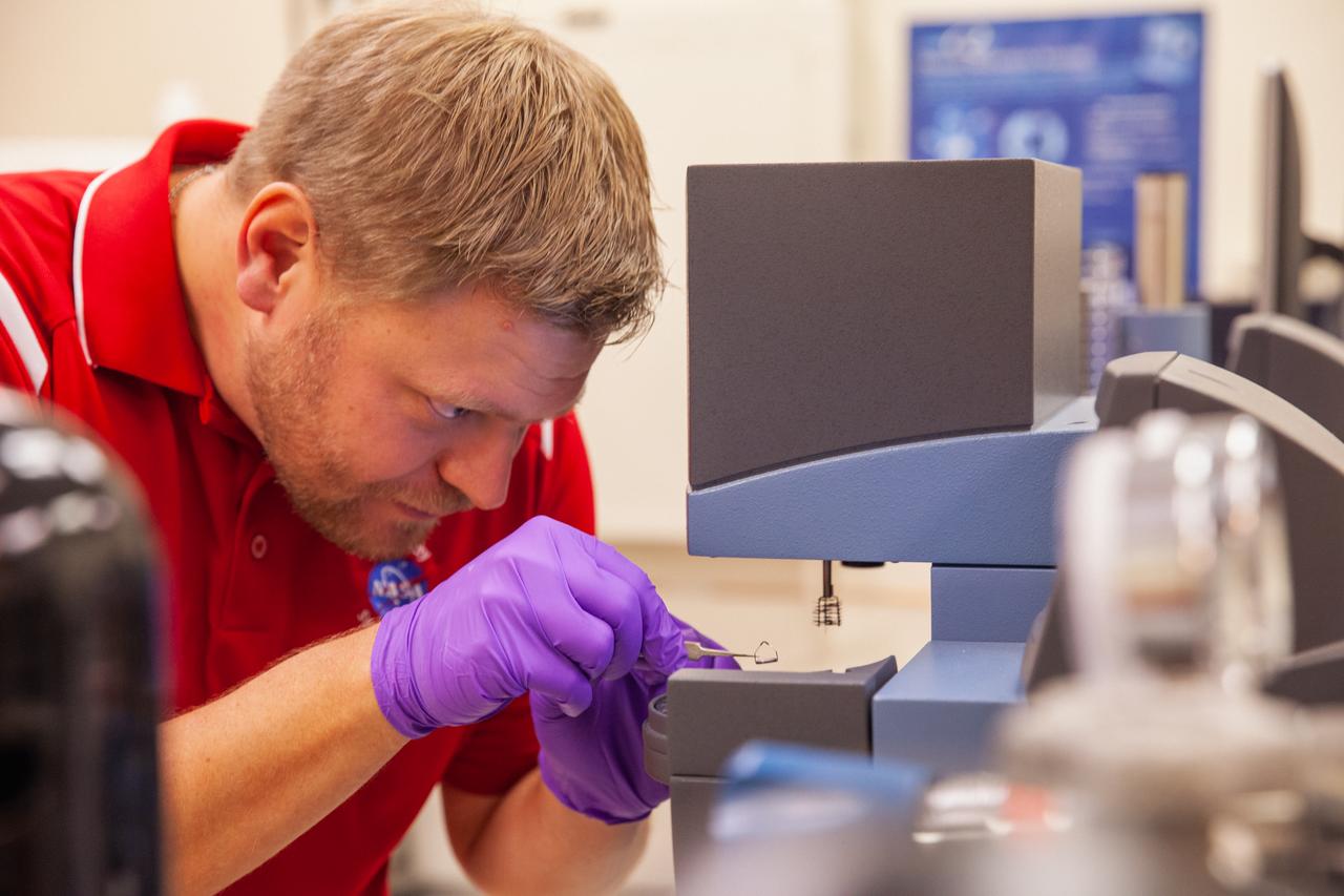 Jerry Buhrow, an engineer in the Materials Analysis Lab, places a sample on a thermal testing unit inside a lab at NASA Kennedy Space Center’s Neil Armstrong Operations and Checkout Building on Oct. 6, 2020.