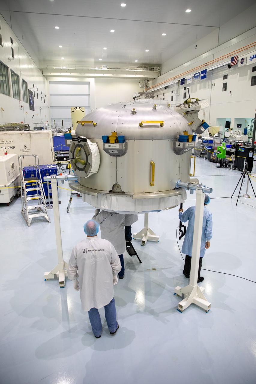 Nanoracks technicians work on the Nanoracks Bishop Airlock inside the Space Station Processing Facility at NASA's Kennedy Space Center in Florida on Oct. 7, 2020. The next-generation Nanoracks payload facility is being prepared for its flight to the International Space Station on SpaceX’s 21st commercial resupply services mission (CRS-21) to the International Space Station. The Bishop Airlock is the first commercially funded airlock for the space station. It will provide payload hosting, robotics testing, satellite deployment, serve as an outside toolbox for station crew spacewalks, and more. CRS-21 is scheduled to launch on a SpaceX Falcon 9 from Kennedy’s Launch Complex 39A.