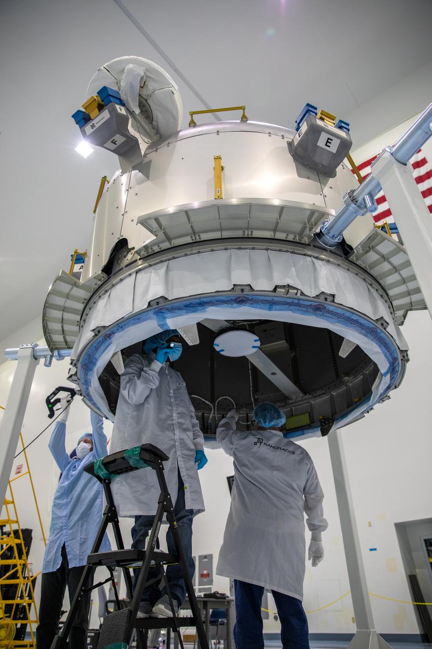 Nanoracks technicians work on the NanoRacks Bishop Airlock inside the Space Station Processing Facility at NASA's Kennedy Space Center in Florida on Oct. 7, 2020. The next-generation Nanoracks payload facility is being prepared for its flight to the International Space Station on SpaceX’s 21st commercial resupply services mission (CRS-21) to the International Space Station. The Bishop Airlock is the first commercially funded airlock for the space station. It will provide payload hosting, robotics testing, satellite deployment, serve as an outside toolbox for station crew spacewalks, and more. CRS-21 is scheduled to launch on a SpaceX Falcon 9 from Kennedy’s Launch Complex 39A.