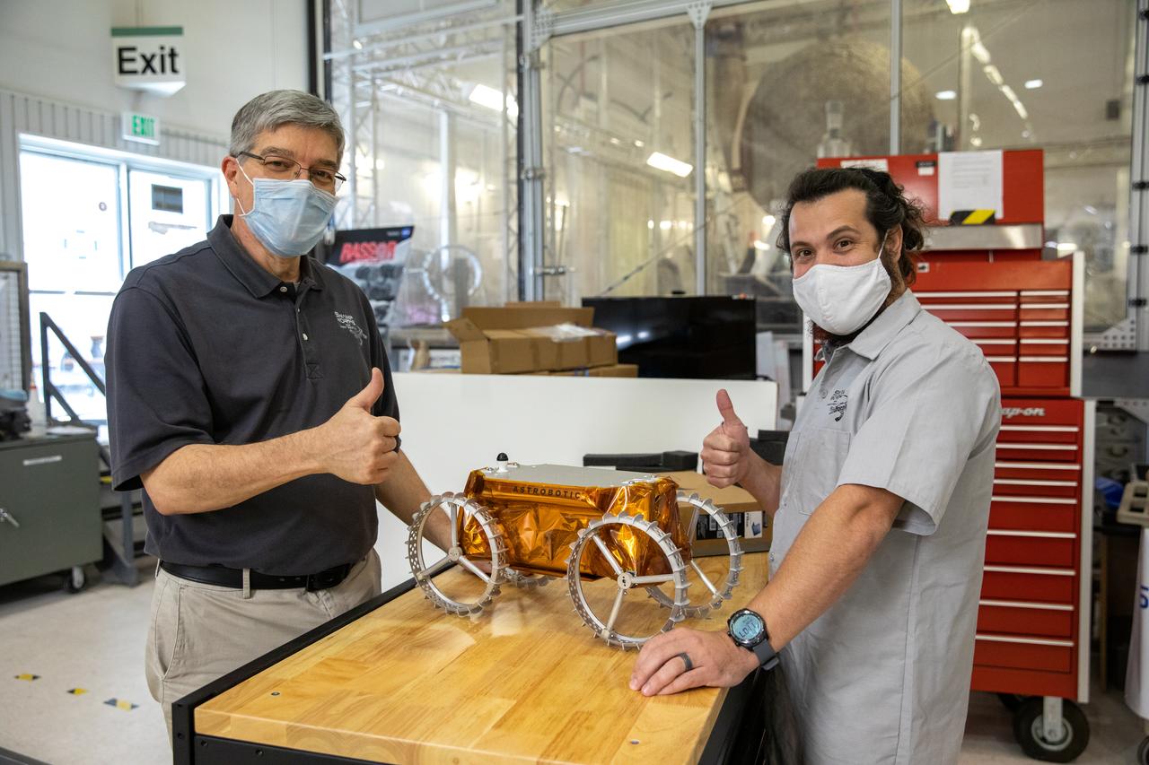 Jim Mantovani, left, and A.J. Nick, with Kennedy Space Center’s Exploration and Research and Technology programs, unbox a CubeRover at the Florida spaceport on Oct. 9, 2020. The rover was delivered by Pittsburgh-based space robotics company Astrobotic, as part of a Small Business Innovative Research (SBIR) award from NASA. Nick will lead CubeRover testing in the coming months in the Granular Mechanics and Regolith Operations (GMRO) Laboratory’s regolith bin, which holds approximately 120 tons of lunar regolith simulant at Kennedy’s Swamp Works. In 2019, NASA announced a $2 million Tipping Point award to develop more mature CubeRover’s payload interfaces and increase its capabilities.