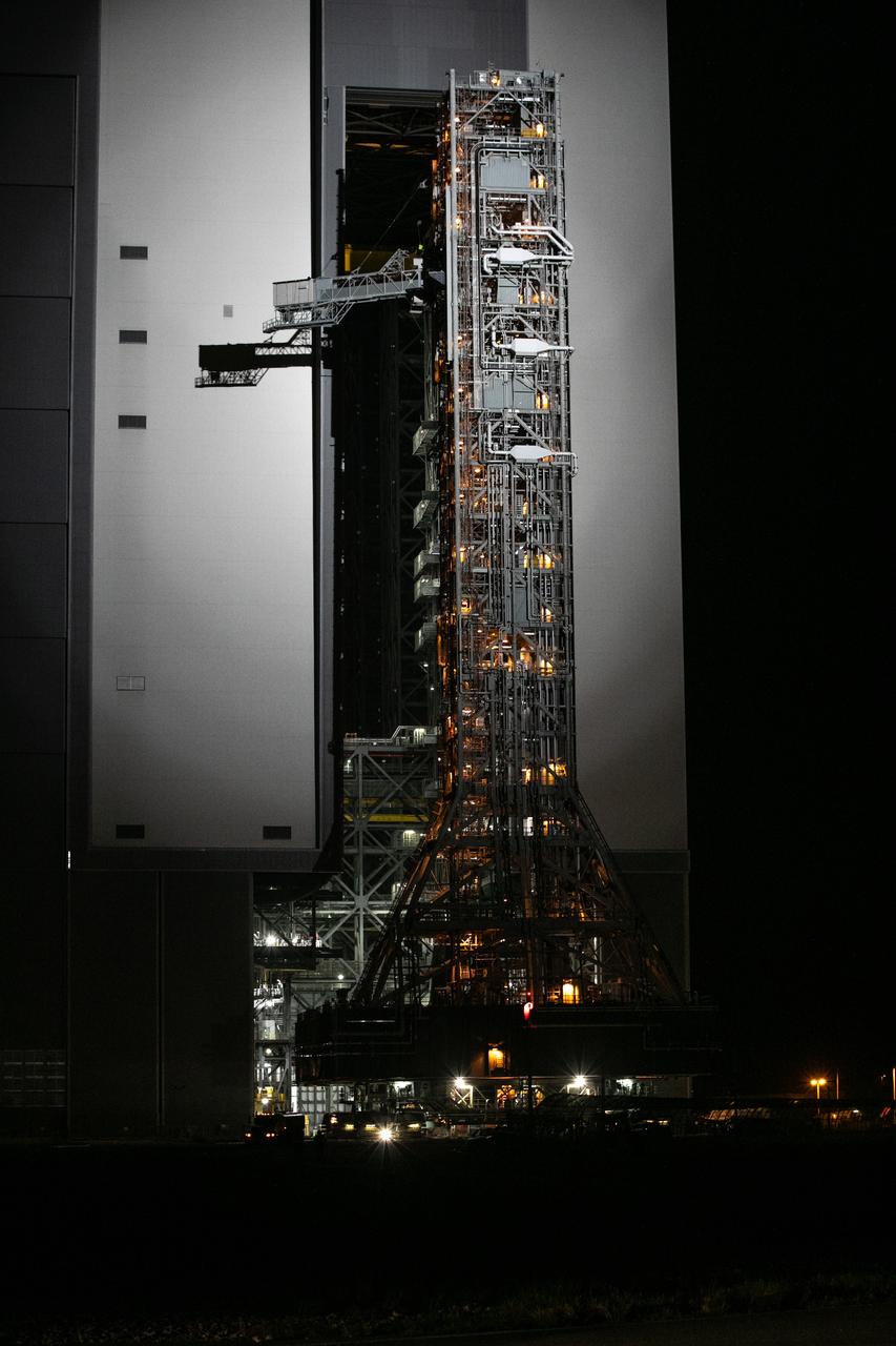 In the early morning on Oct. 20, 2020, the mobile launcher for the Artemis I mission begins its rollout atop crawler-transporter 2 from the Vehicle Assembly Building at NASA’s Kennedy Space Center in Florida. The nearly 400-foot-tall mobile launcher is being rolled to Launch Pad 39B. During its two-week stay at the pad, engineers with Exploration Ground Systems and Jacobs will perform several tasks, including a timing test to validate the launch team’s countdown timeline, and a thorough, top-to-bottom wash down of the mobile launcher to remove any debris remaining from construction and installation of the umbilical arms. Artemis I will test the Orion spacecraft and Space Launch System as an integrated system ahead of crewed flights to the Moon. Under the Artemis program, NASA will land the first woman and the next man on the Moon in 2024.