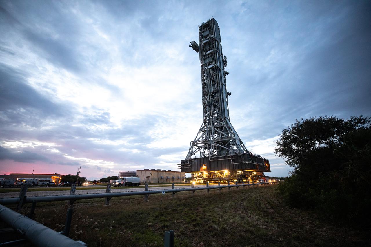 During sunrise on Oct. 20, 2020, the mobile launcher for the Artemis I mission, atop crawler-transporter 2, arrives at the ramp leading up to Launch Pad 39B at NASA’s Kennedy Space Center in Florida. The nearly 400-foot-tall mobile launcher will remain at the pad for two weeks, while engineers with Exploration Ground Systems and Jacobs will perform several tasks, including a timing test to validate the launch team’s countdown timeline, and a thorough, top-to-bottom wash down of the mobile launcher to remove any debris remaining from construction and installation of the umbilical arms. Artemis I will test the Orion spacecraft and Space Launch System as an integrated system ahead of crewed flights to the Moon. Under the Artemis program, NASA will land the first woman and the next man on the Moon in 2024.