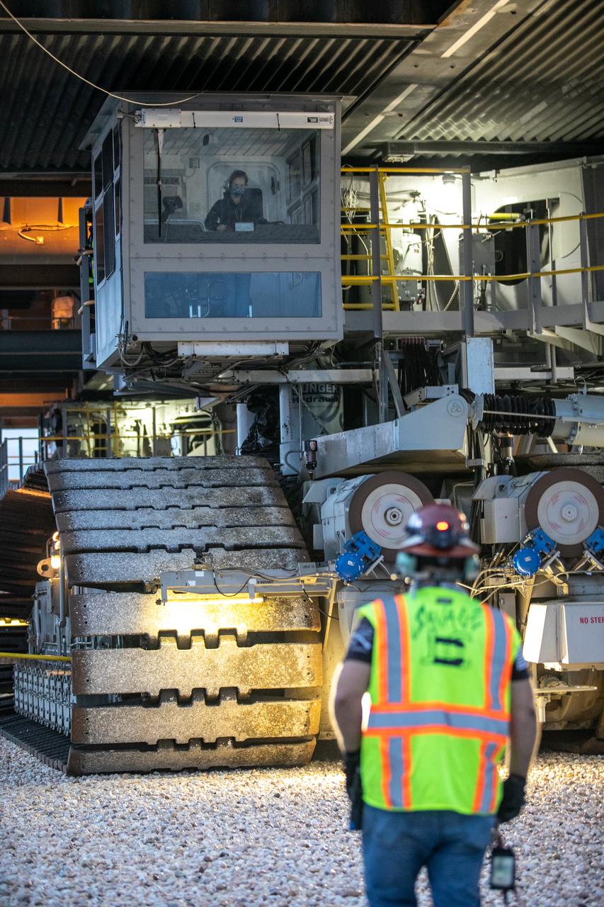 During sunrise on Oct. 20, 2020, the mobile launcher for the Artemis I mission, atop crawler-transporter 2 (CT-2), arrives at Launch Pad 39B at NASA’s Kennedy Space Center in Florida. In view inside the CT cab is Breanne Rohloff, crawler-transporter driver and mechanical engineer with Jacobs. The nearly 400-foot-tall mobile launcher will remain at the pad for two weeks, while engineers with Exploration Ground Systems and Jacobs will perform several tasks, including a timing test to validate the launch team’s countdown timeline, and a thorough, top-to-bottom wash down of the mobile launcher to remove any debris remaining from construction and installation of the umbilical arms. Artemis I will test the Orion spacecraft and Space Launch System as an integrated system ahead of crewed flights to the Moon. Under the Artemis program, NASA will land the first woman and the next man on the Moon in 2024.